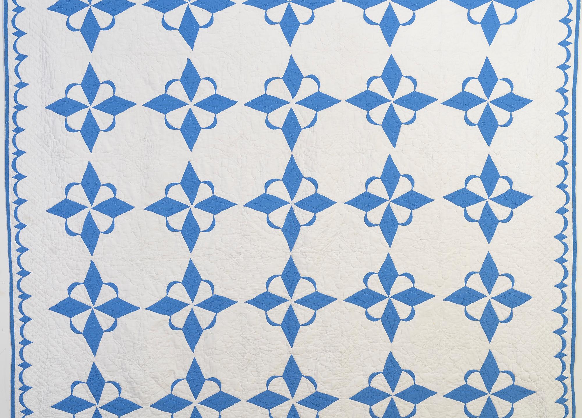 This unusual star variation goes by several names, most often Crescent Star or Star of the West. It is done in a beautiful shade of medium blue. It is well quilted with a variety of curvilinear designs. The border is a creative continuation of the