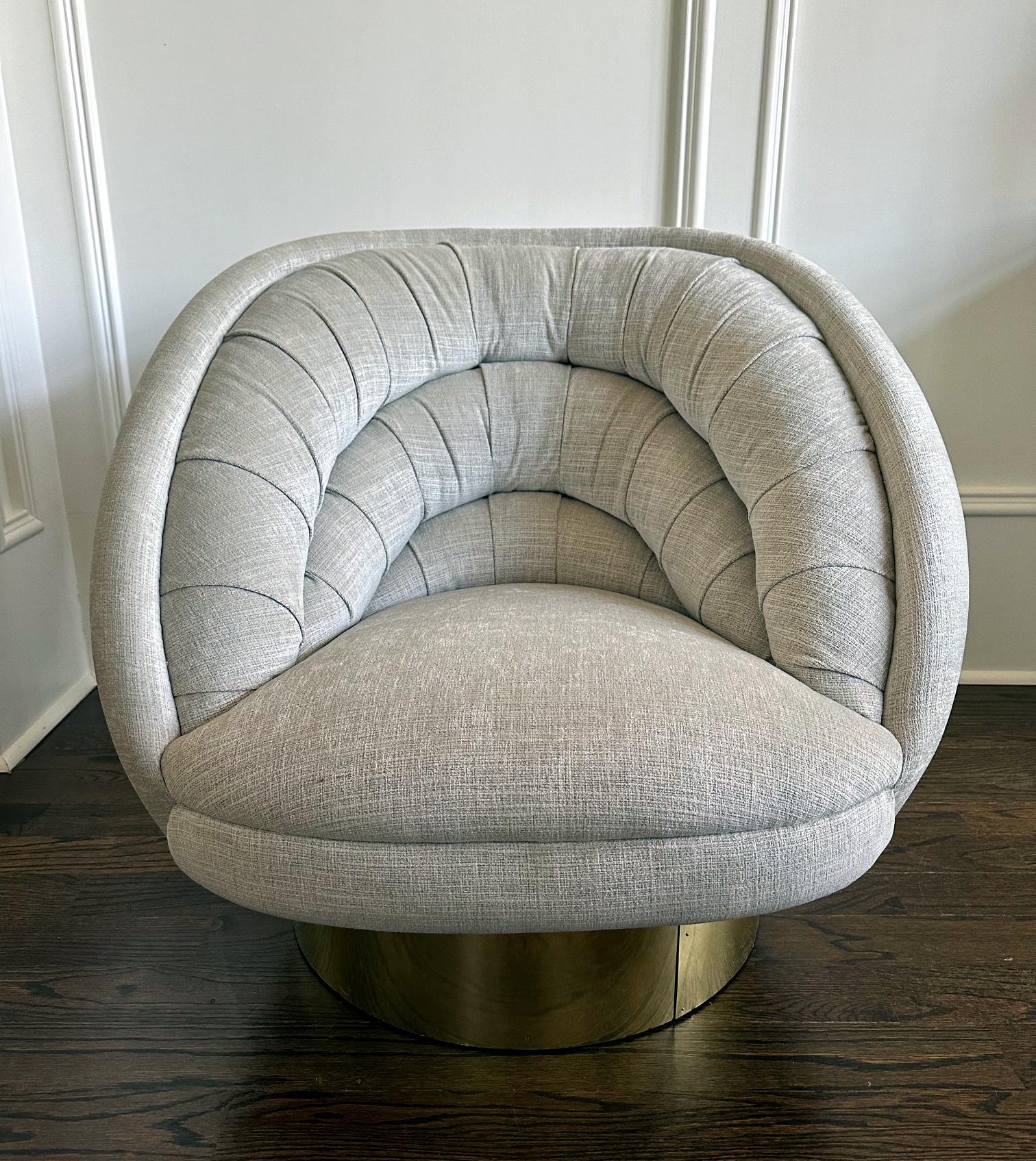 A glamorous swivel lounge chair designed and manufactured by Vladimir Kagan (1927-2016) circa 1970-80s. Known as Ellipse or Crescent chair, the model was designed by Vladimir Kagan in 1976. The chair on offer features a brass clad base and a heavy