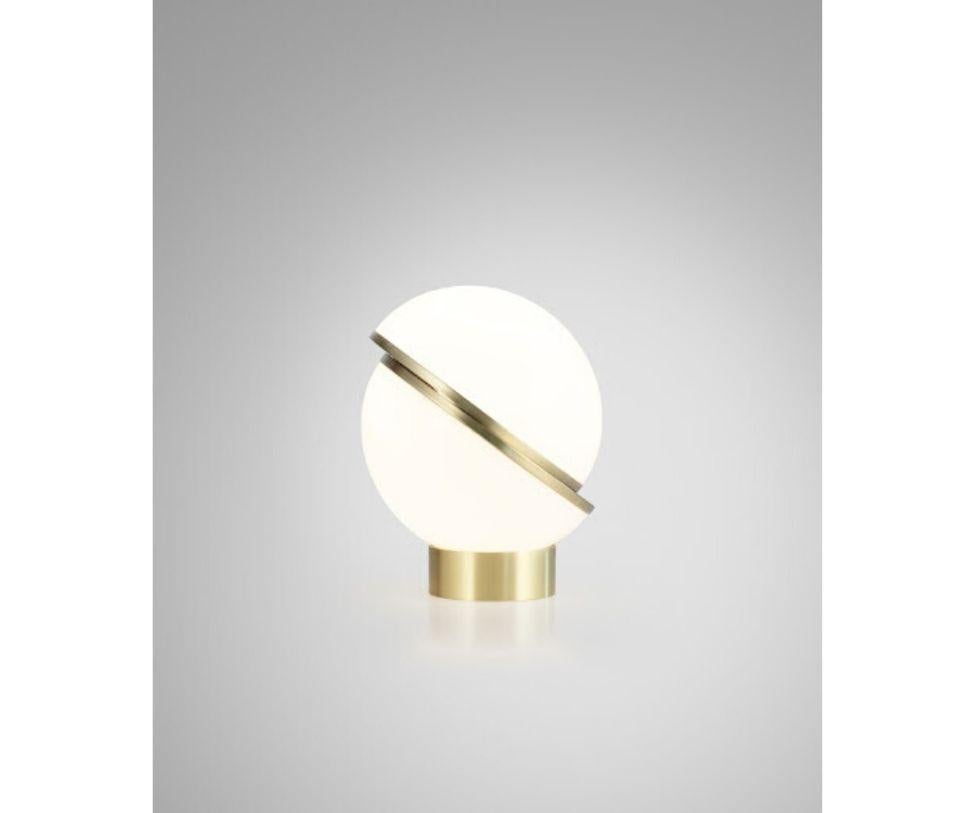 An illuminated sphere sliced in half to reveal a crescent-shaped brushed brass fascia, crescent seamlessly combines the solid and the opaque.

Technical specification
Dimensions: Height 19.1 in x diameter 15 in
Materials: Opaque acrylic, brushed