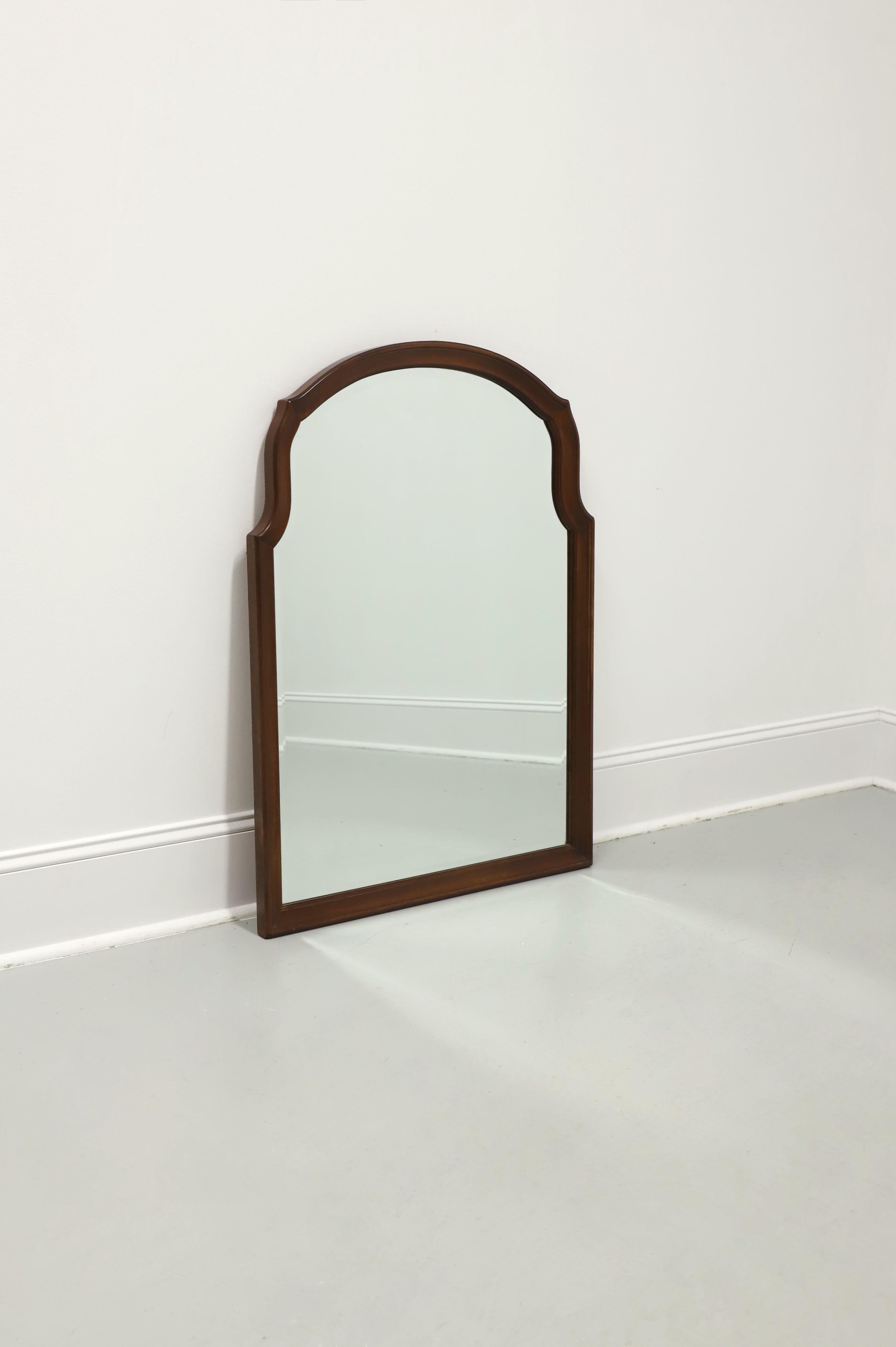 A Traditional style wall mirror by Cresent. Beveled mirrored glass in a frame made from Pennsylvania cherry wood with a rounded arched top and flat bottom. Made in Gallatin, Tennessee, USA, circa 1998.

Measures: 30w 1.5d 40.25h, Weighs