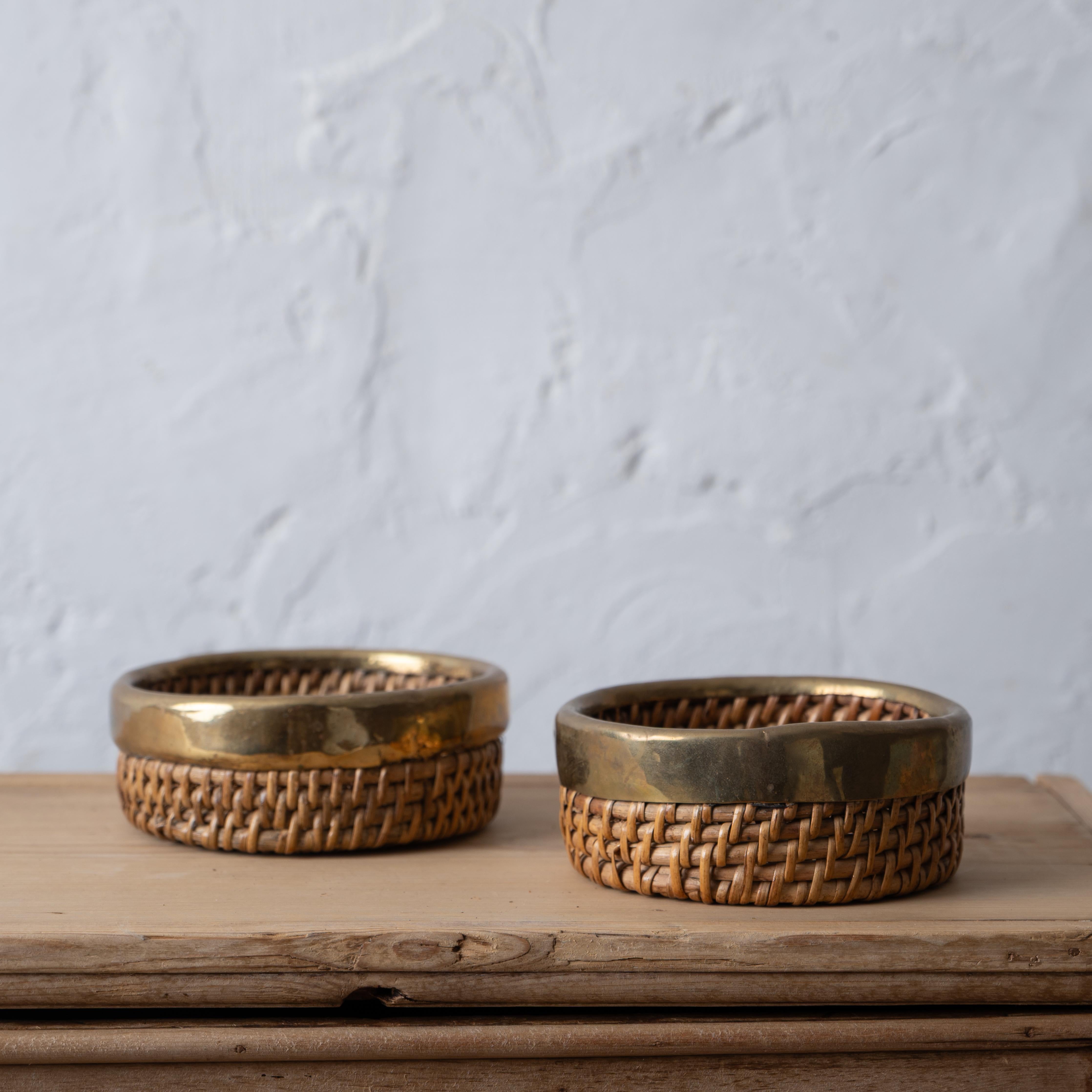 Crespi style pencil reed and brass baskets - coasters or catch-alls, 1960s.

5 ½ inches wide by 2 inches tall

