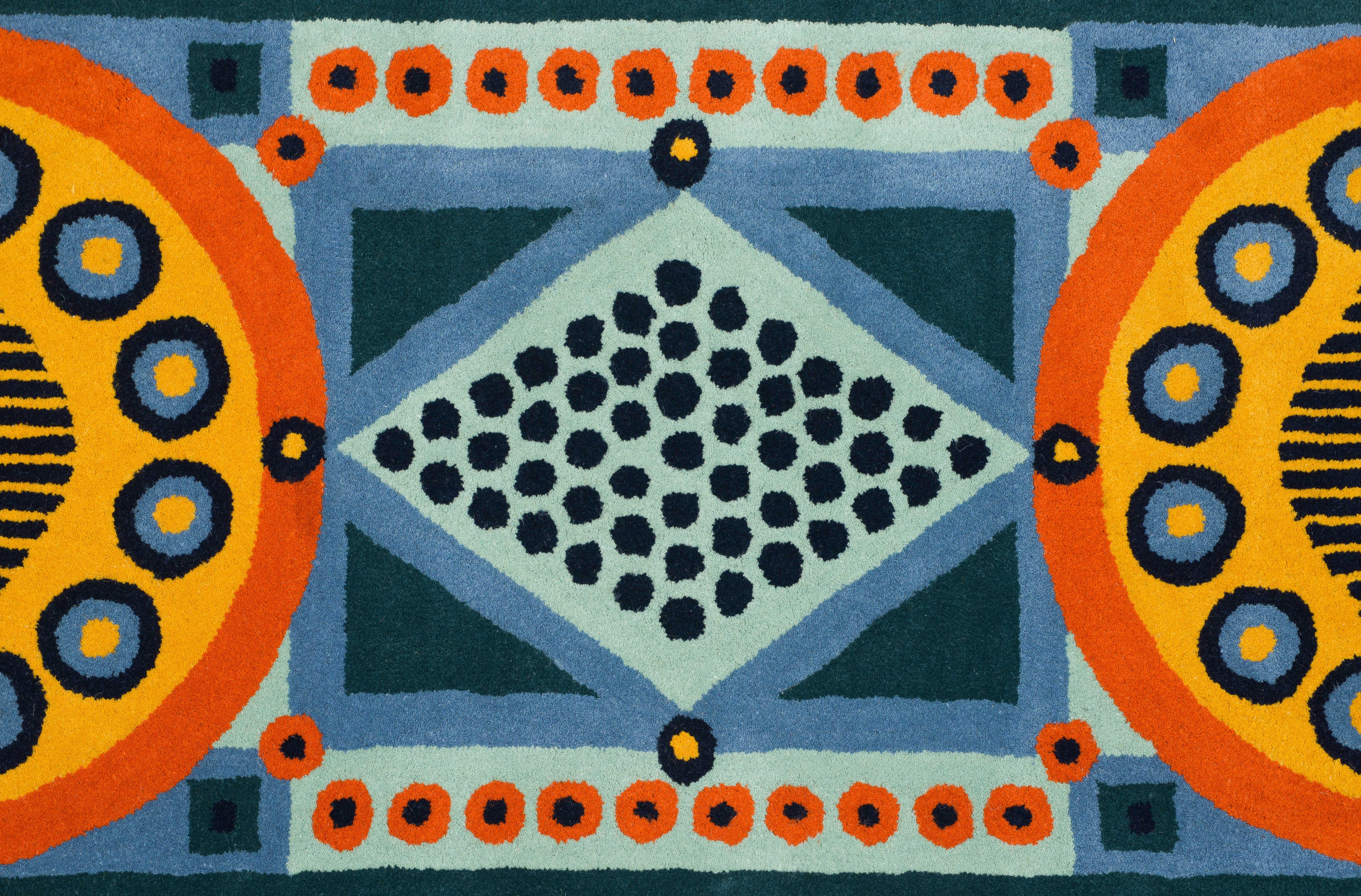100% Wool hand-tufted pile rug. Makers mark at one end: 'C'  inside a Bell shape. Manufactured in India. 

Cressida Bell is a British designer specialising in textiles and interiors. From her London studio, she produces a wide range of products