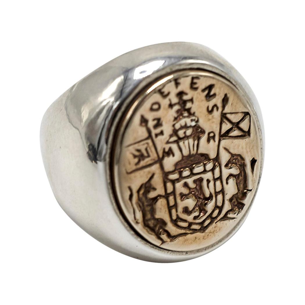 Crest Signet Ring 14k Yellow Gold Medal Bezel  with Base of Ring in Sterling Silver Mens or Unisex
Designer: J Dauphin

Inspired by Queen Mary of Scots ring. Gold signet-ring; engraved; shoulders ornamented with flowers and leaves. Oval bezel set
