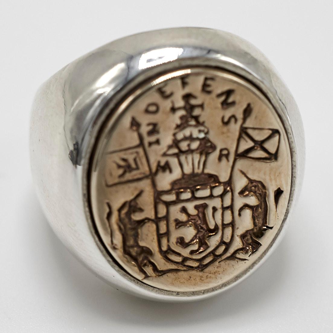 Crest Signet Ring Sterling Silver Bronze Queen Mary Family Crest Lion Unicorn J Dauphin
Unisex

Inspired by Queen Mary of Scots ring. Gold signet-ring; engraved; shoulders ornamented with flowers and leaves. Oval bezel set with silver intaglio