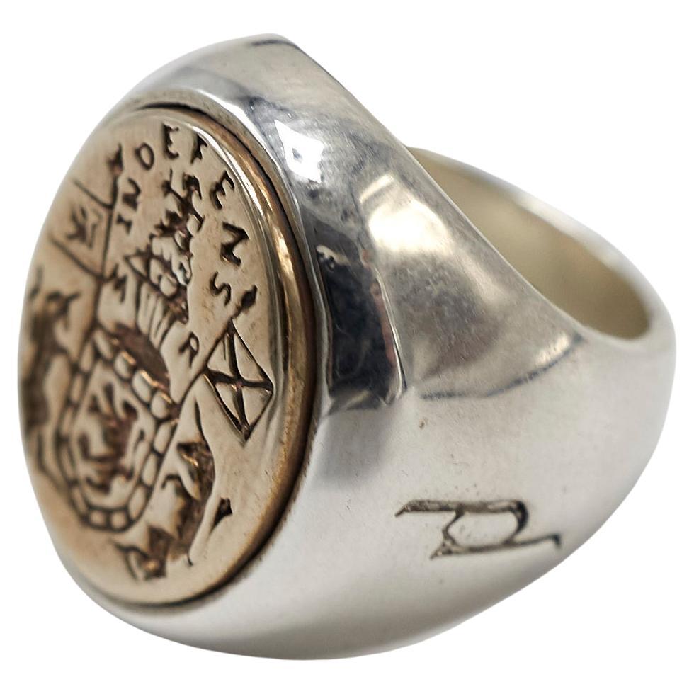 Crest Signet Ring 14k White Gold 14k Yellow Gold Unisex J Dauphin

Inspired by Queen Mary of Scots ring. Gold signet-ring; engraved; shoulders ornamented with flowers and leaves. Oval bezel set with silver intaglio depicting achievement of Mary
