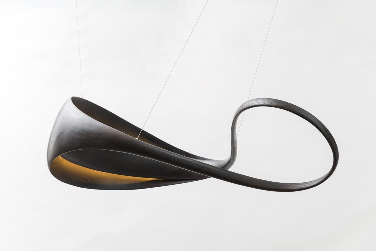 The Crevasse Series is inspired by topography, its twisting forms reminiscent of roads. The sculpture’s curvilinear forms split, open, and expand to reveal a wide basin, internally illuminated by LEDs.

Having grown up around his carpenter