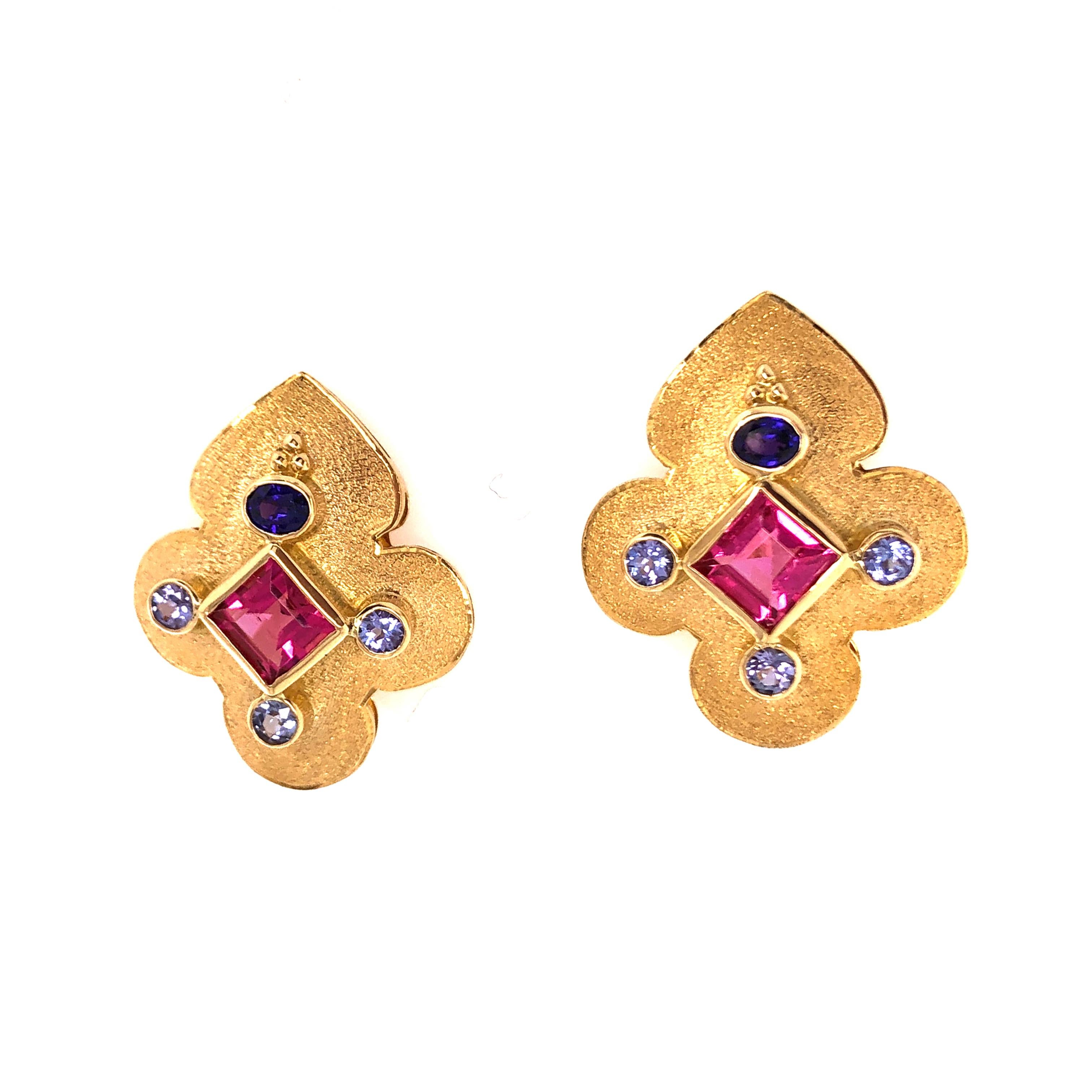 These super interesting Crevoshay 18K yellow gold Tanzanite and Pink Tourmaline earrings are it! They are sure to be a conversation starter anywhere you want to be noticed. 

Stamped: 18KT, (hallmark image)