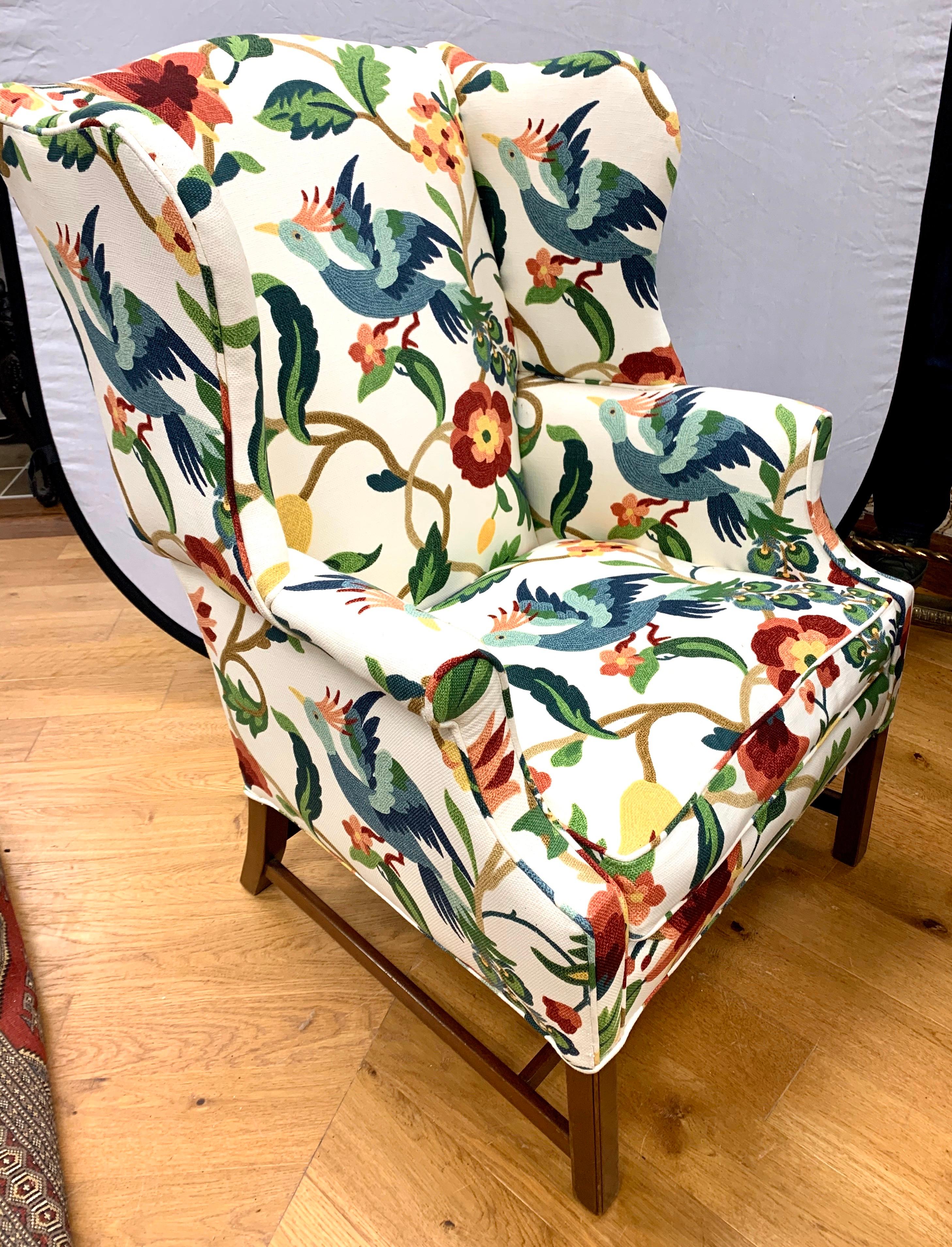 Stunning crewelwork floral upholstered fabric on the large wingback reading chair. The fabric is magnificent.