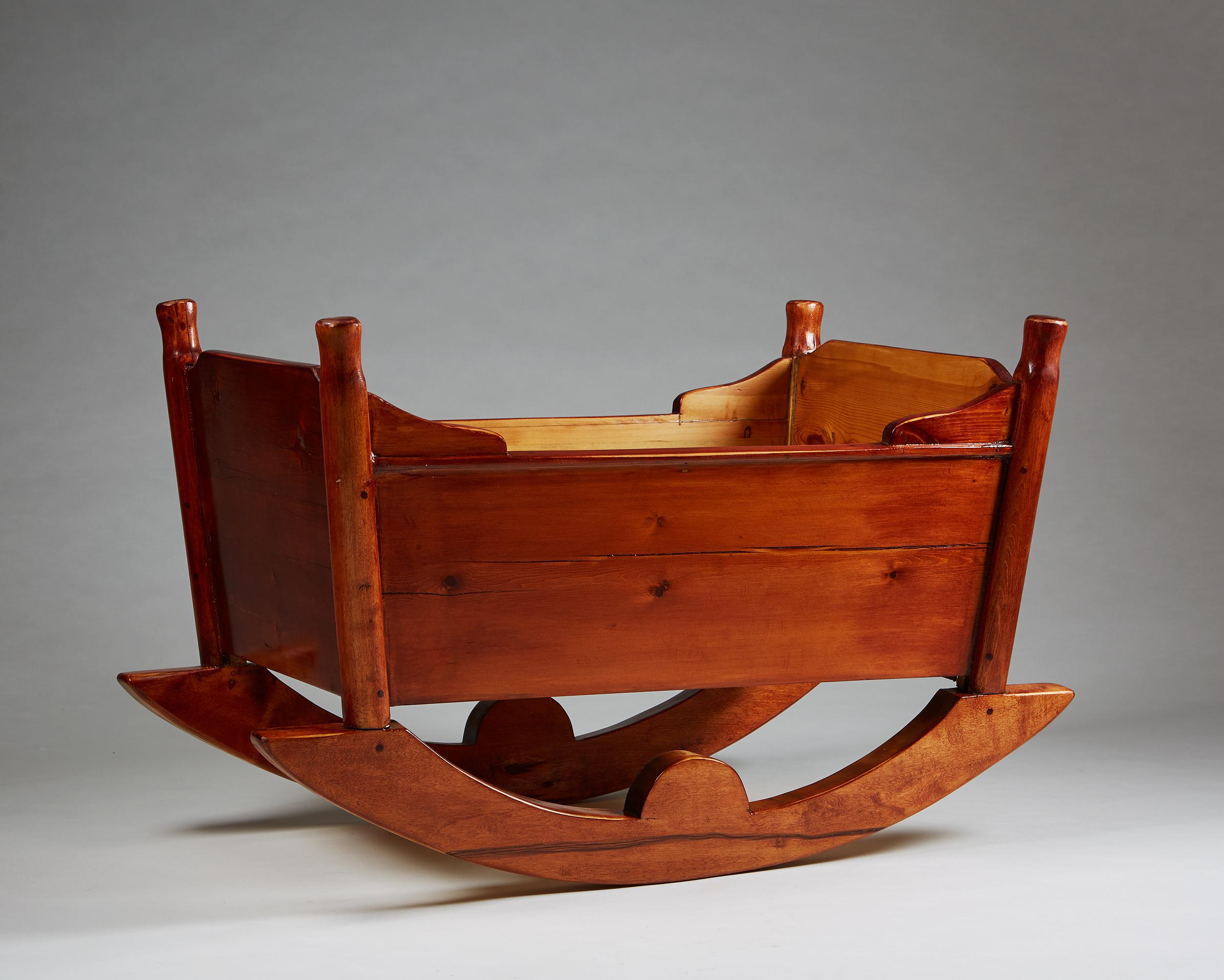 Crib designed by Carl Malmsten,
Sweden, 1924.

Stained pine.

Carl Malmsten was a renowned Swedish furniture designer and architect who lived from 1888 to 1972. He is considered one of Sweden's most influential designers of the 20th
