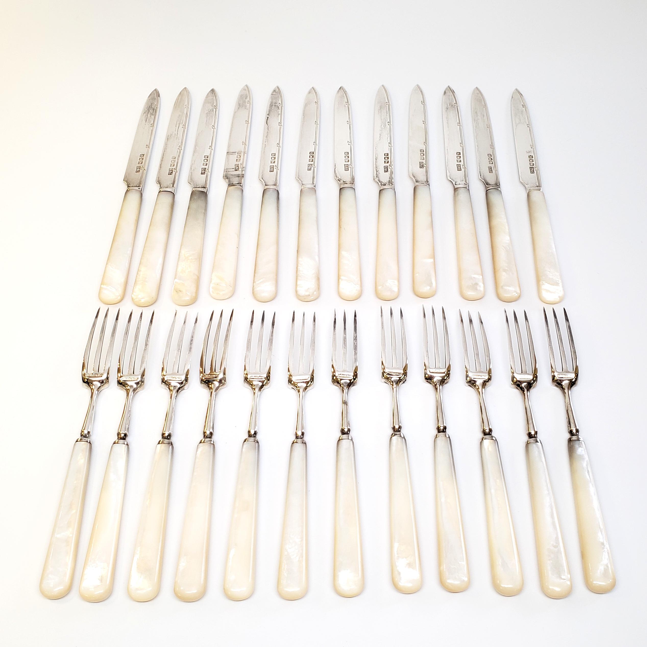 Antique sterling silver and mother of pearl handle fruit service, compromised of 12 fruit forks and 12 fruit knives by Crichton Bros.

Gorgeous set of George V fruit forks and knives, made in London by Crichton Bros in 1917. The shimmer in the