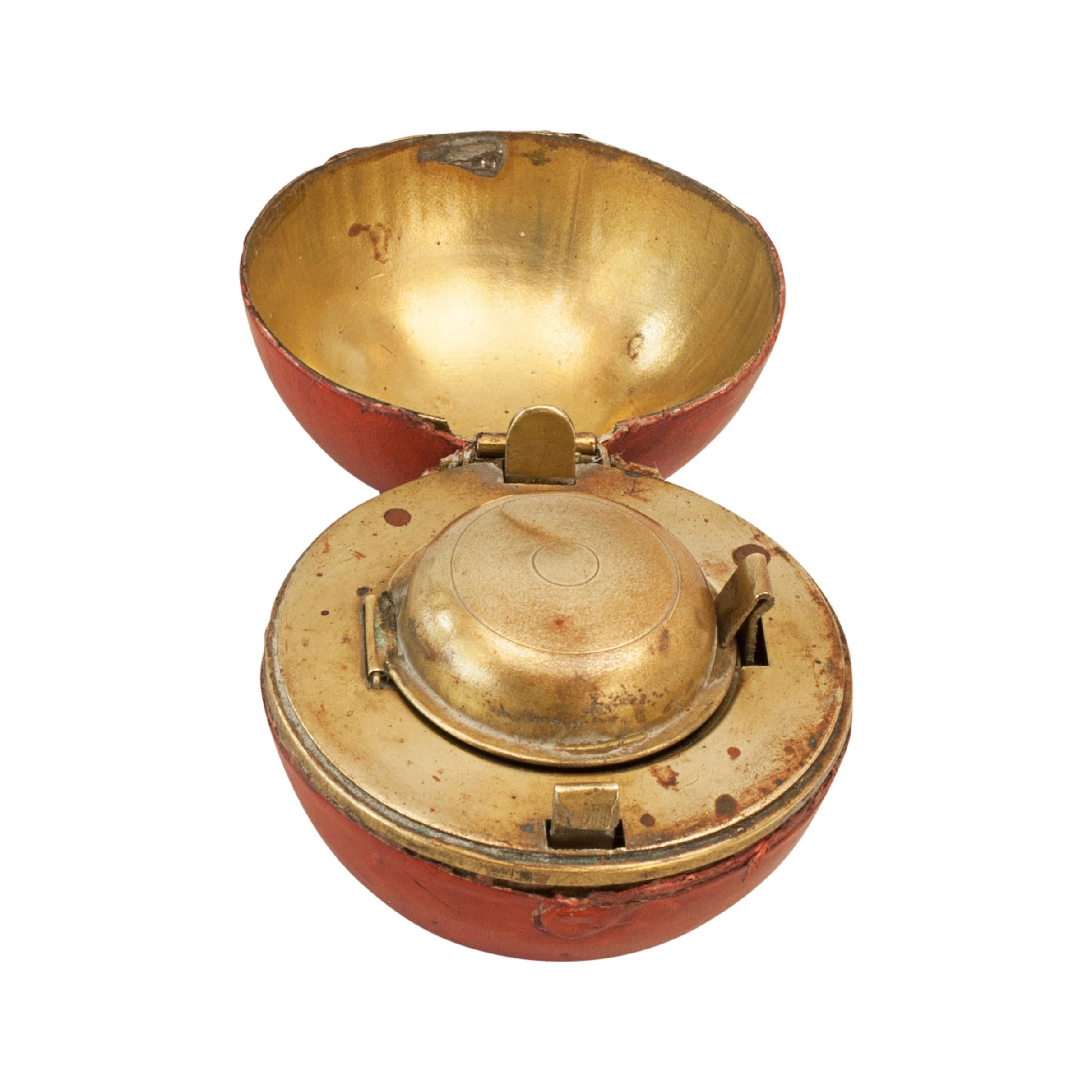 Rare Novelty Cricket Inkwell.
A wonderful leather covered traveling inkwell in the shape of a cricket ball. This is a very desirable, rare and unusual object made from brass and covered in imprinted leather to imitate a ball. It is hinged in the