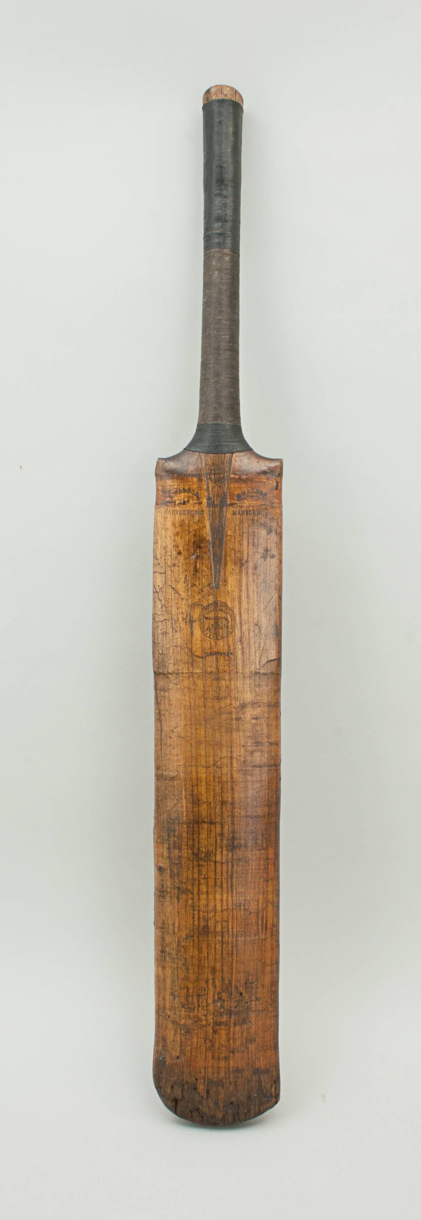 Victorian cricket bat with silver shield, 1887.
A good early willow cricket bat made by B. Warsop, Marylebone, England. The bat has a rounded back, cord strung handle and very attractive patination. The shoulders are embossed with the maker's name