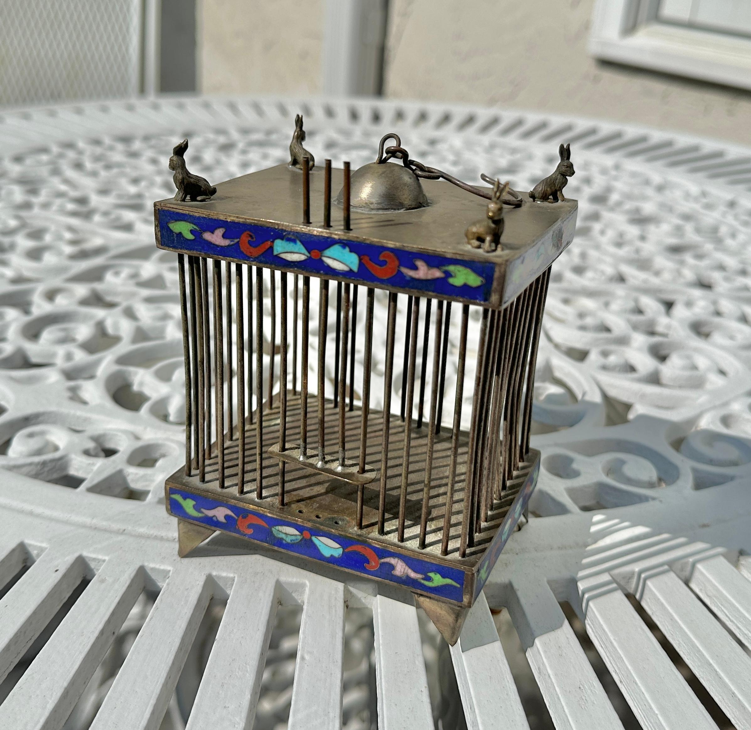 This is a fantastic antique 19th Century Chinese Cricket Cage decorated with Cloisonne Enamel with silver Rabbits on the top! 
The cage is silver with beautiful cloisonne enamel decoration.  
The cage is 5.5 inches tall, 4 inches wide, and 3 inches