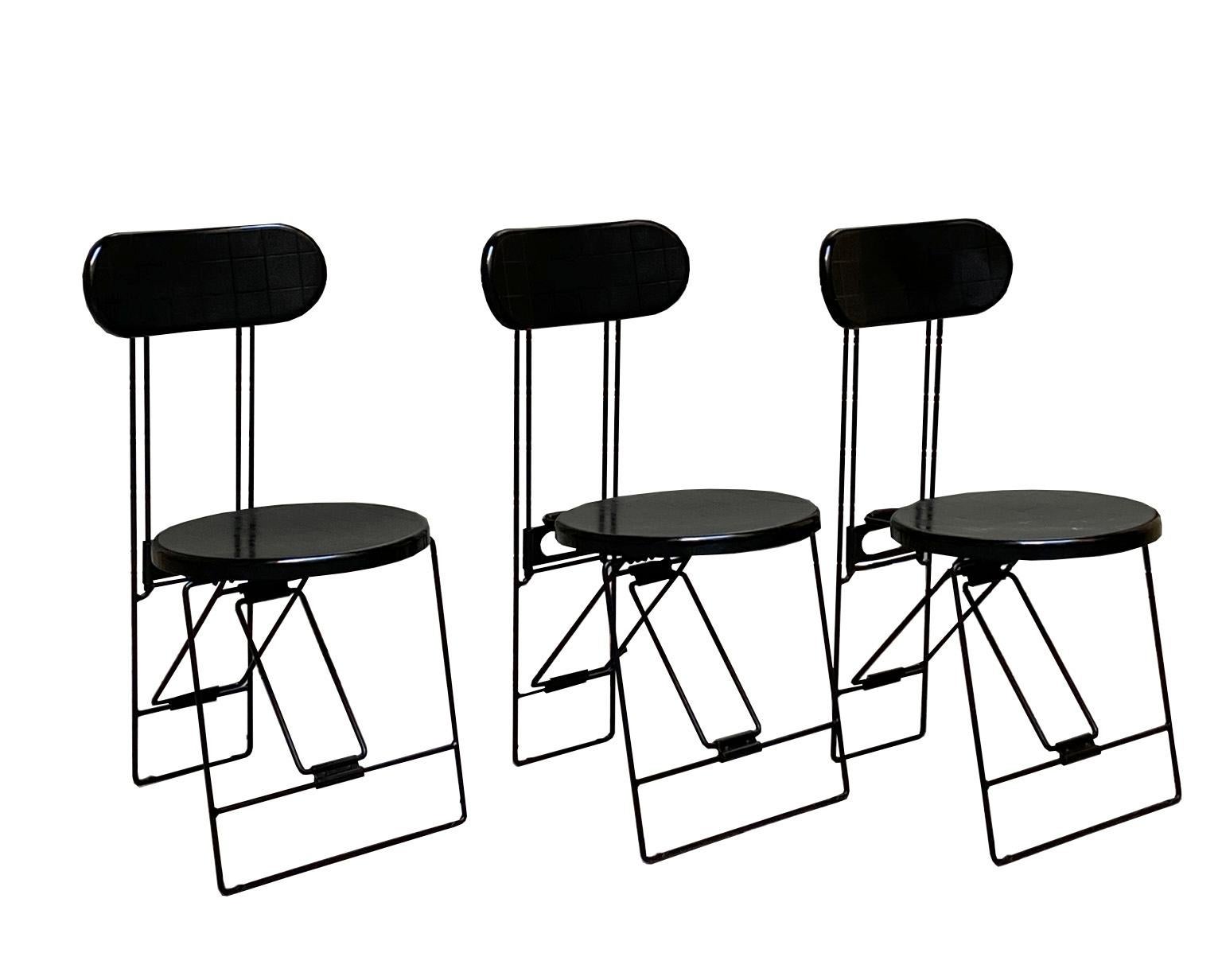 The chair was designed by Andries van Onck and Kazuma Yamaguchi for Magis, Italy.
Memphis style folding chairs from 1983.
The seating and the back is made of heavy quality black pvc.
The black-coated frame is made of massive wire steel.
 