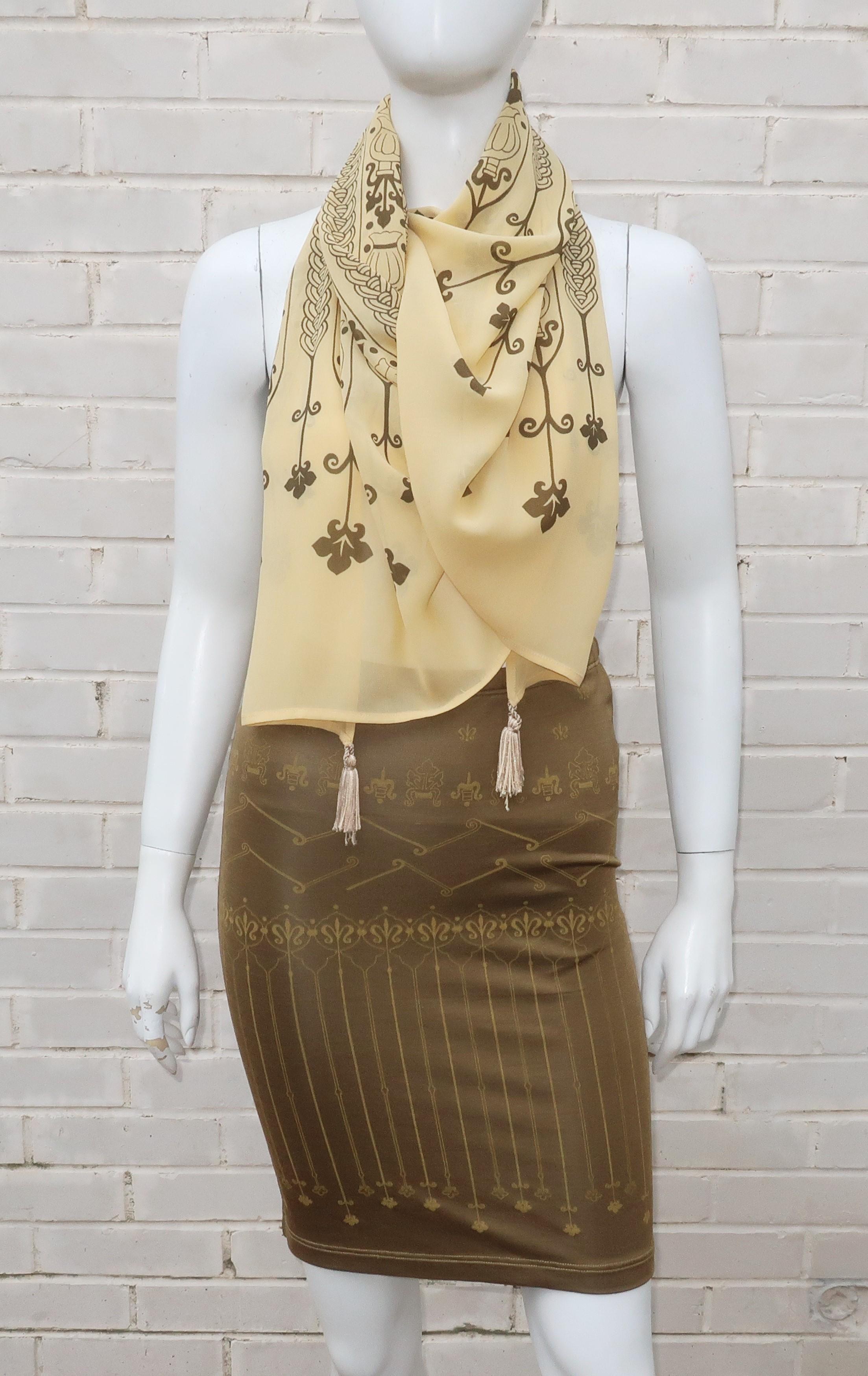 This Italian ensemble by Crimson puts style into spandex!  The body conscious stretch skirt is a slinky jersey fabric consisting of rayon and spandex with an Egyptian revival print all in a bronzed brown tone.  The coordinating scarf is a buttery