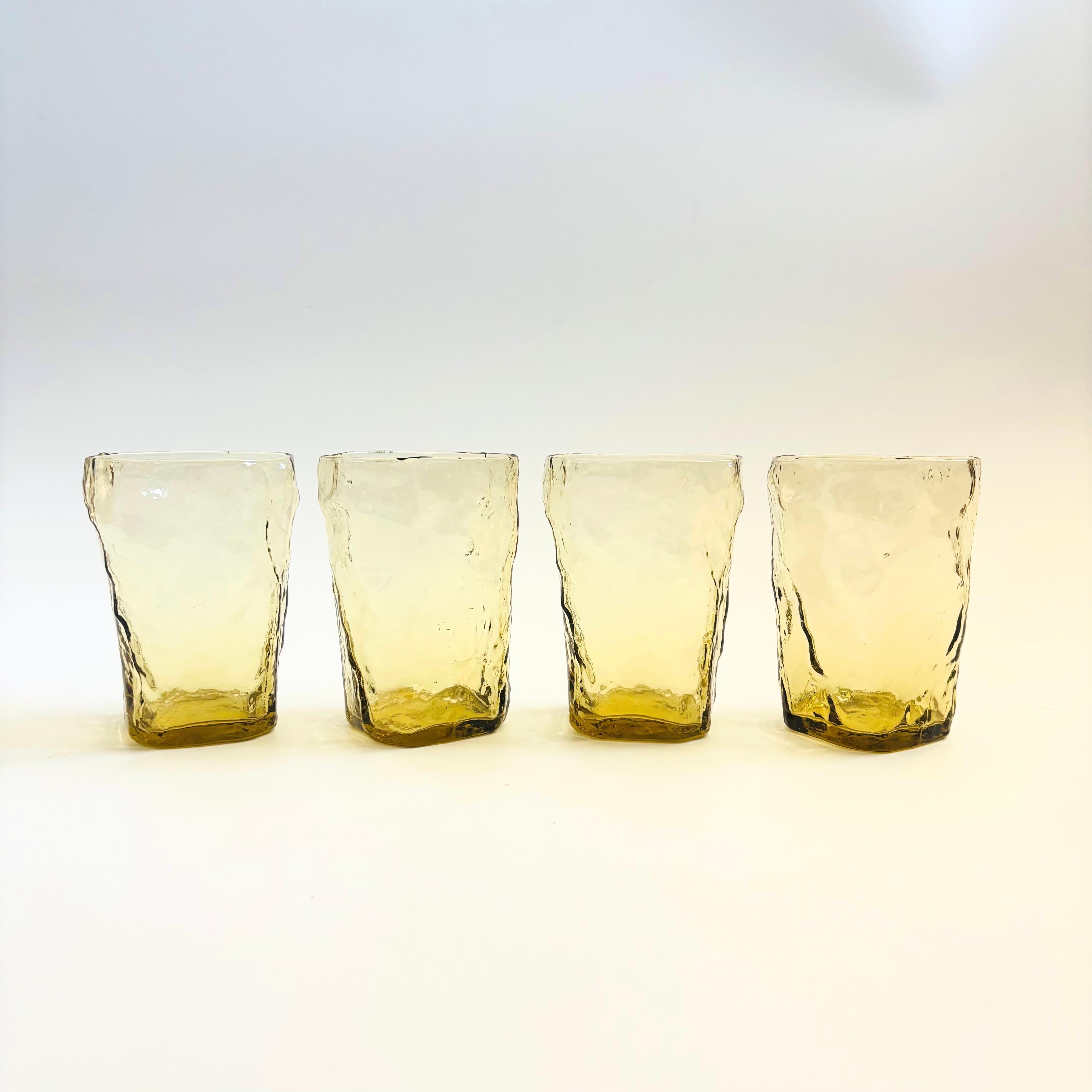 A set of 4 mid century pale yellow crinkle glass tumblers. Each glass has a great organic shape. Made by Morgantown in the topaz color.

