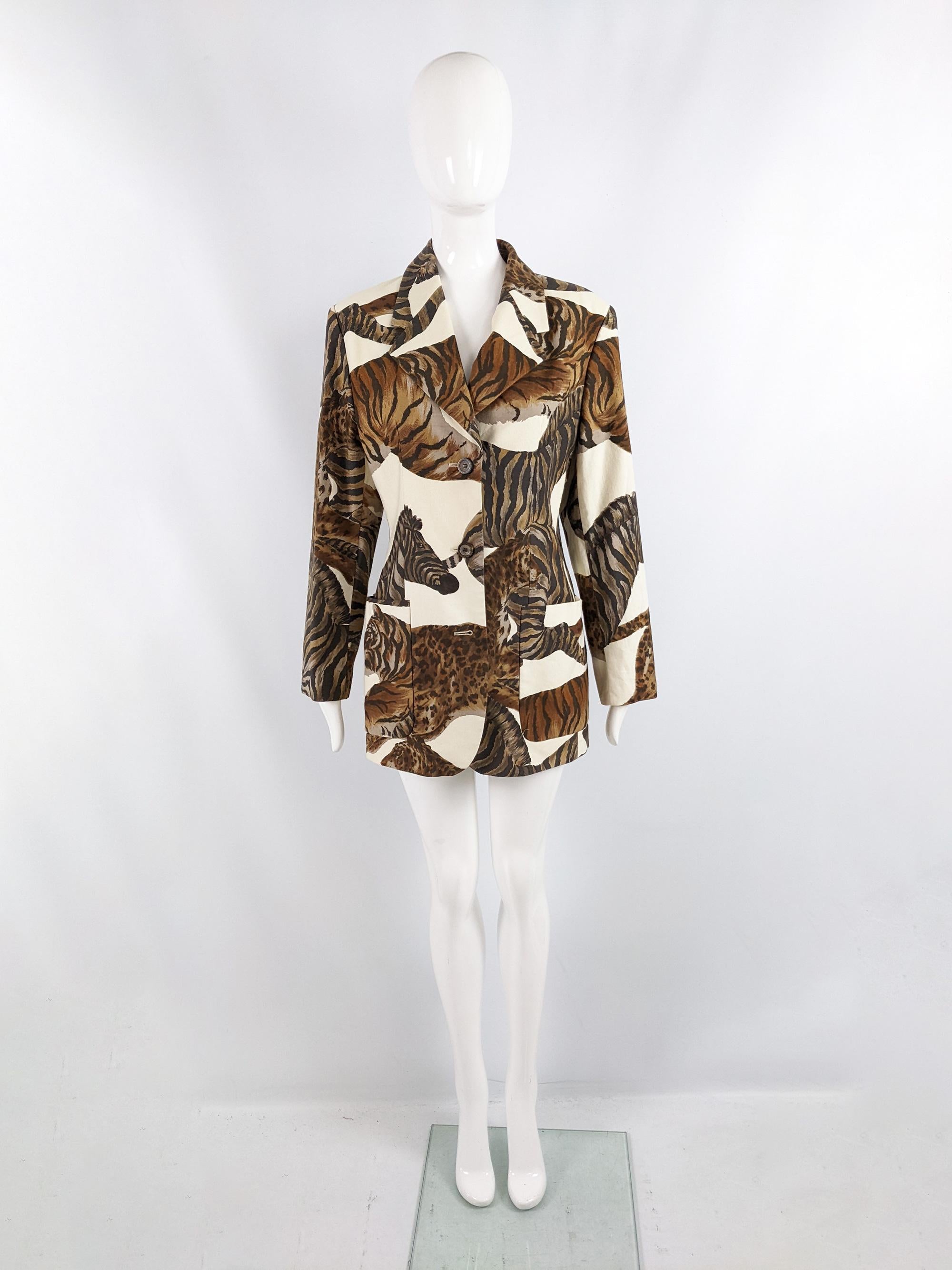 An incredible vintage womens blazer jacket from the 80s by luxury fashion house, Escada for their Crisca line. In panels of white cotton with an amazing animal pattern throughout, featuring tigers and zebras that are beautifully aligned at the back