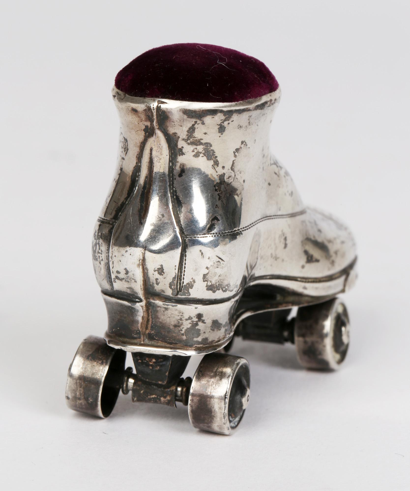 Charming Edwardian silver roller skate pin cushion by Chisford & Norris, Birmingham 1909. The roller skate is well constructed and stands fitted to a roller skate base with life like sideway movements on swivel axle wheels which also turn. The boot