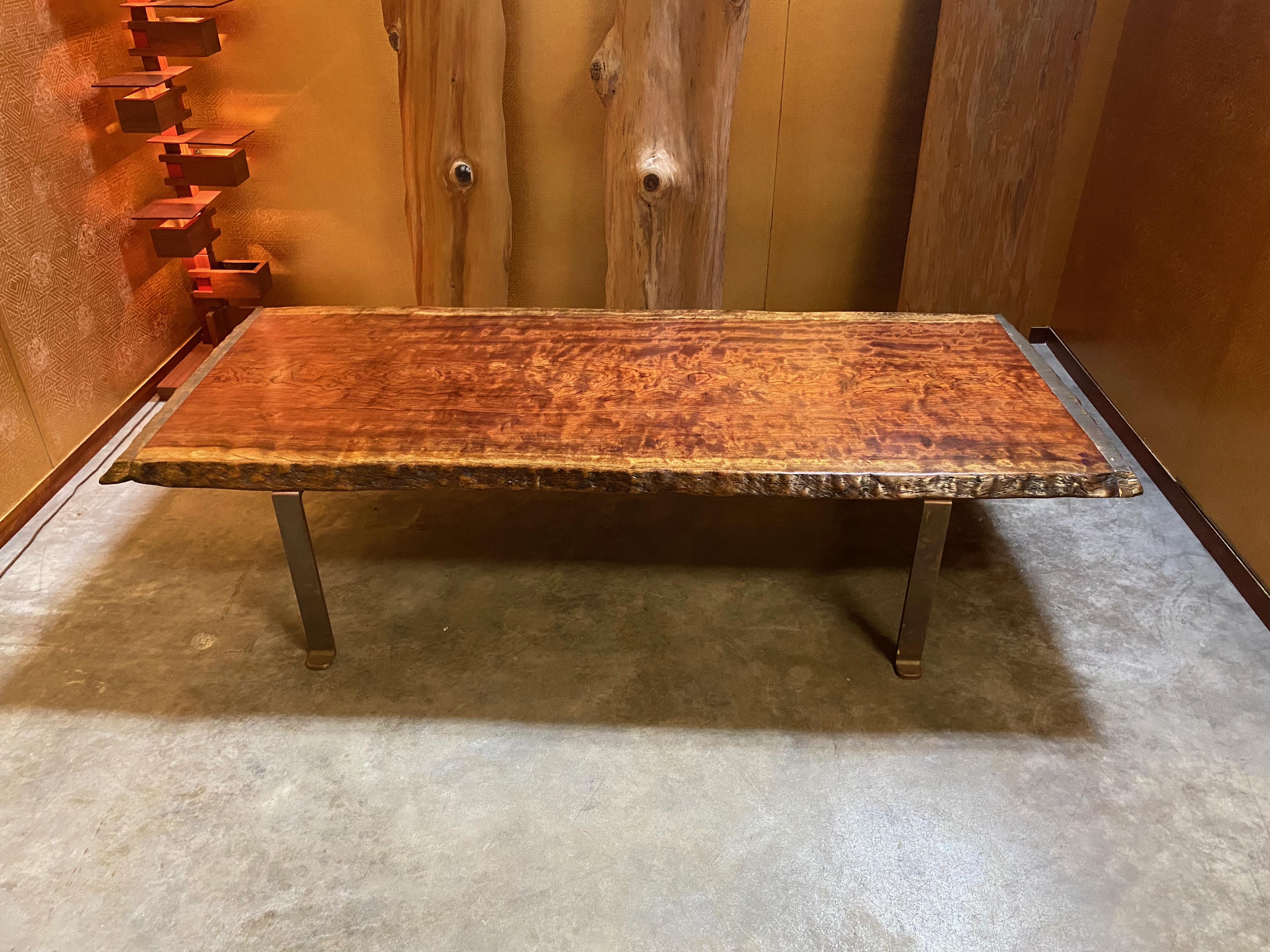 Let us introduce you to an exquisite Crisp coffee table with brass legs and live edge slab with bronze moldings, a true masterpiece of furniture design that showcases the beauty of natural wood and exceptional craftsmanship. This exceptional piece