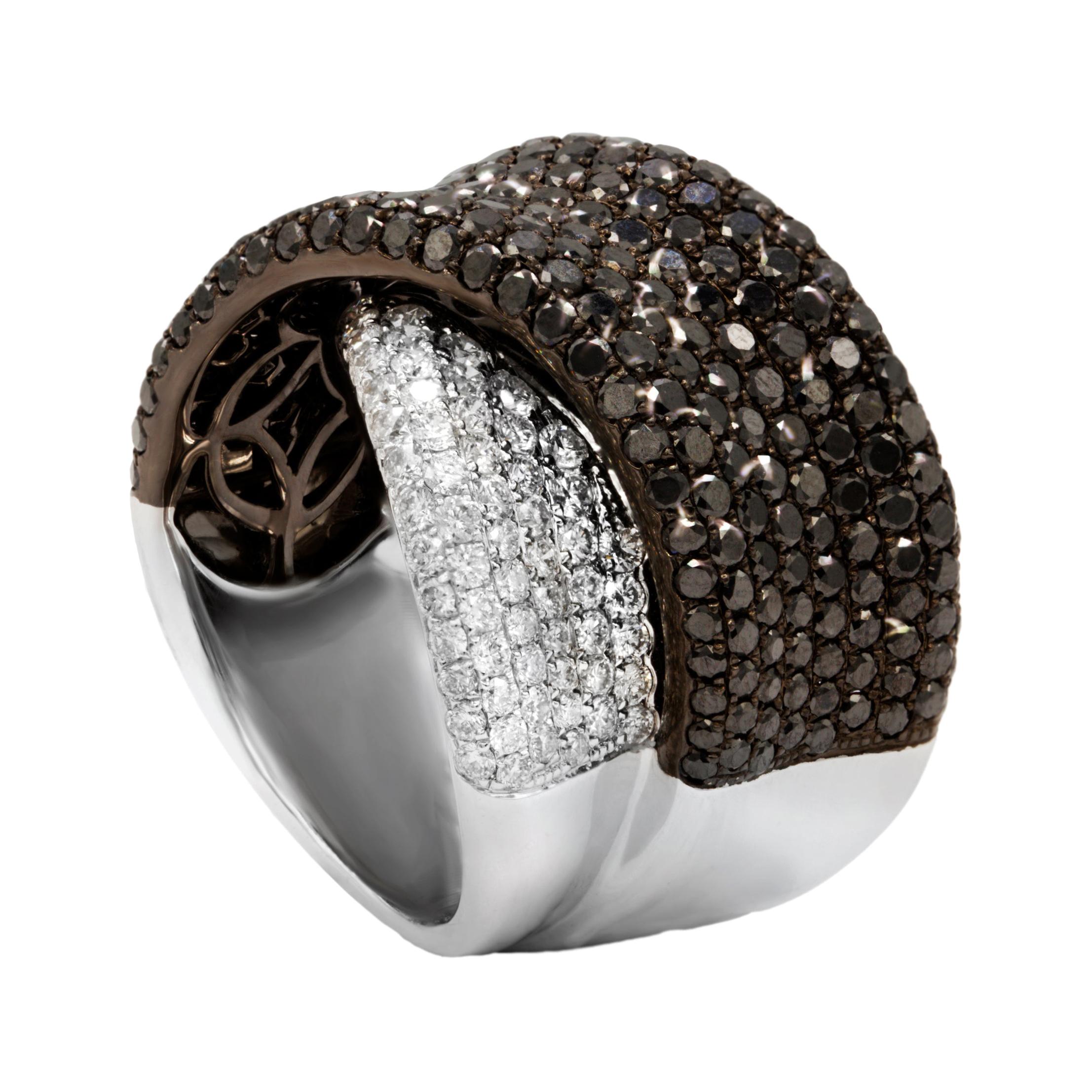 Criss cross black and white diamond ring with micropave round diamonds (b+w) total 4.85ct set in 18kt white gold.
