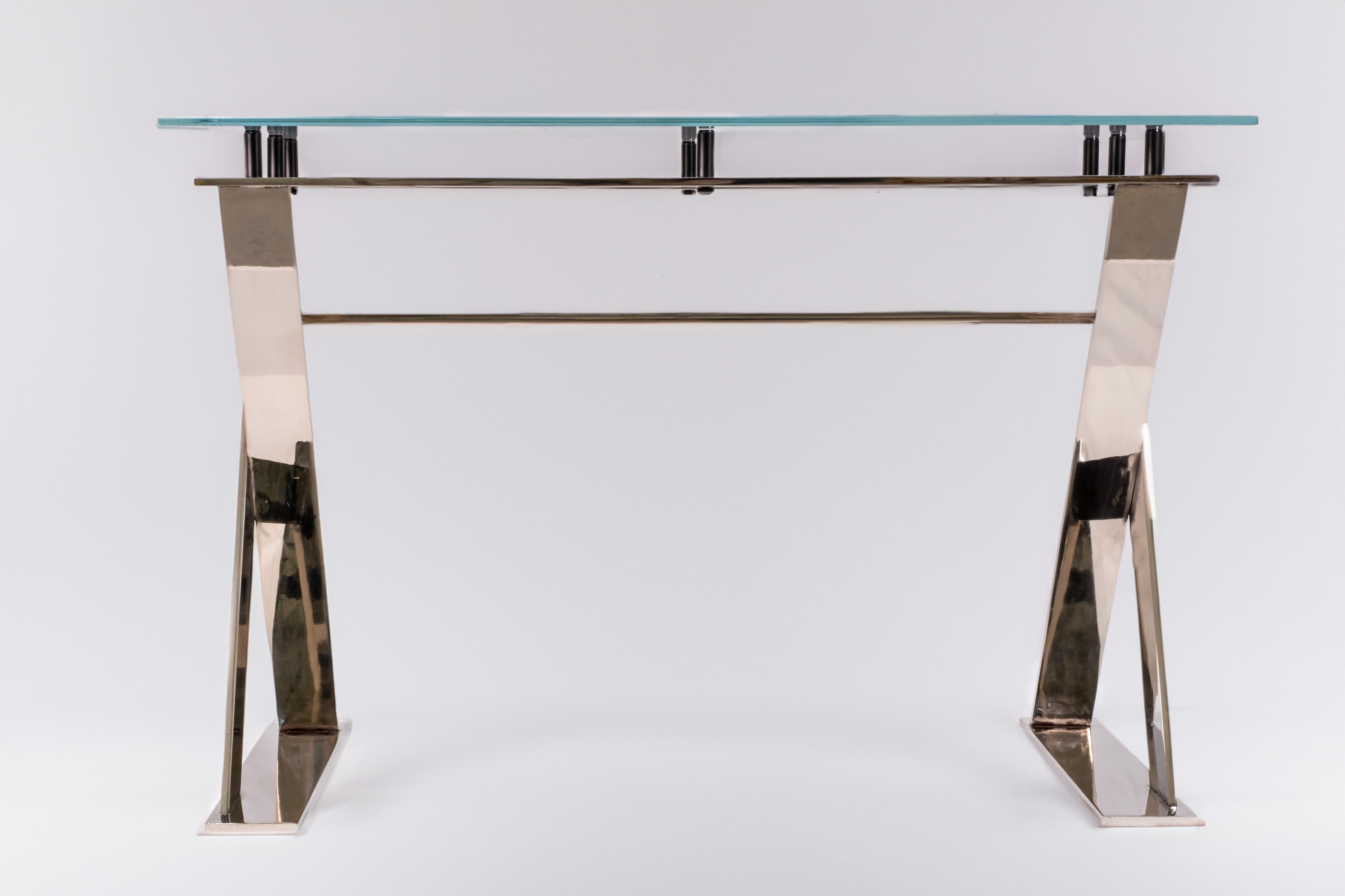 Introducing our exquisite nickel-plated criss-cross desk, meticulously handcrafted in our Westhampton Beach, NY studio. This stunning piece is expertly fashioned from hand-cut and polished steel, resulting in a flawless finish. The desk is