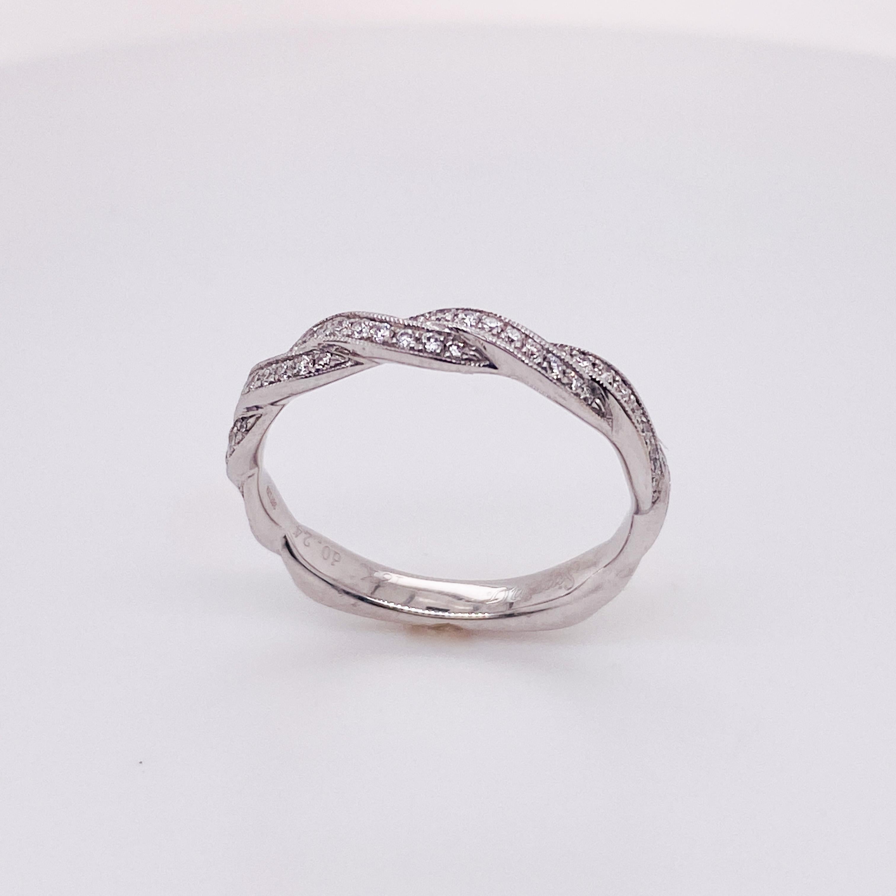 Ribbons of diamonds twine across the top of your finger in this gorgeous 18 karat white gold ring. The bottom of the ring has squared Euroshank corners to keep it from spinning on your finger. Stack this band with any of your favorite rings.  
The