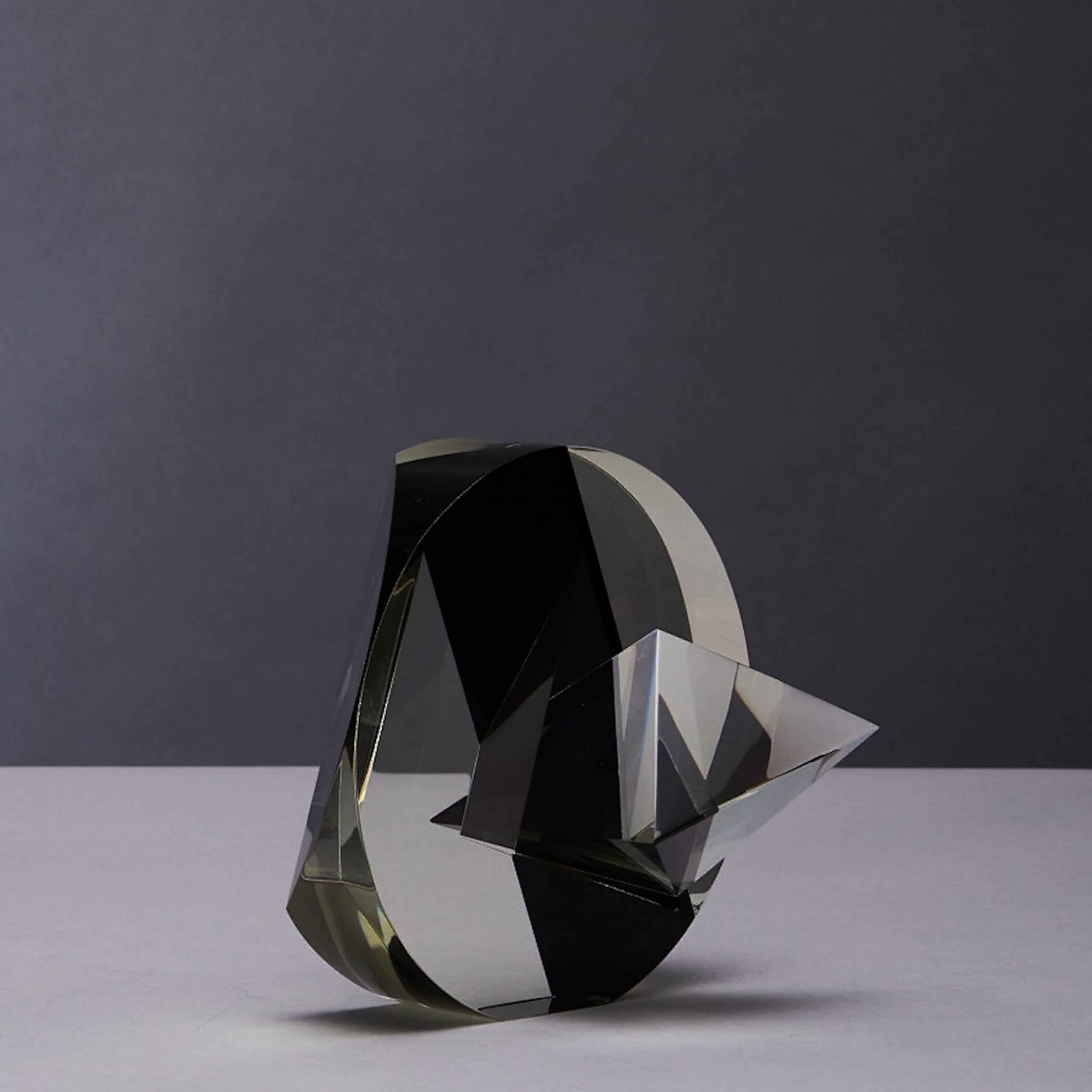 The sculpture is hand cut in circles and triangles, piercing the circular shape of clear and black optical glass, by Vlastislav Janacek is Czeck (signed). 
After graduating with a glass cutter he was successfully graduated from the School of Applied