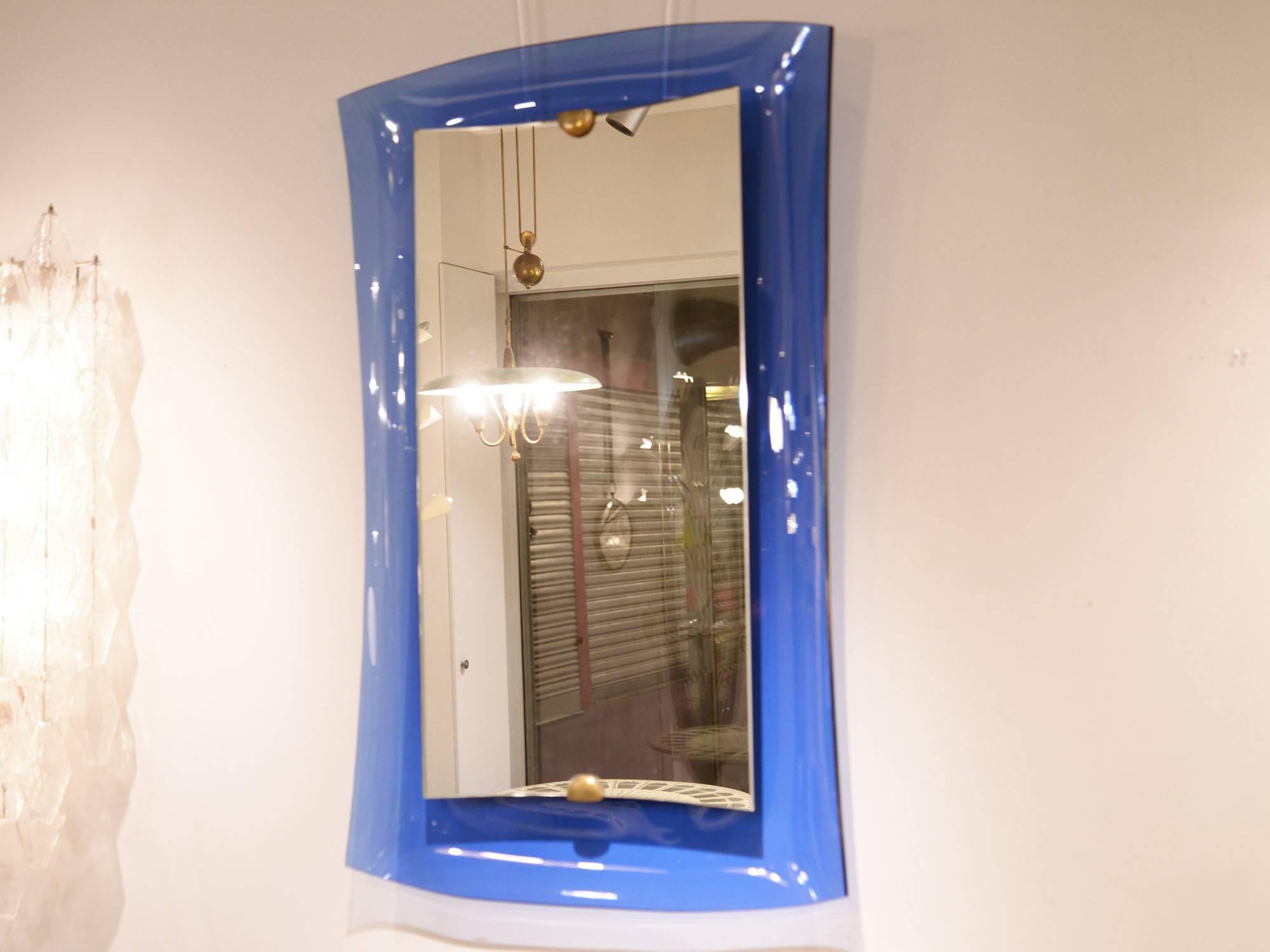 Cristal Art
Mirror
Blue tinted glass, mirror glass, brass
Italy, circa 1950.
Measures: H 101 x W 63 cm.