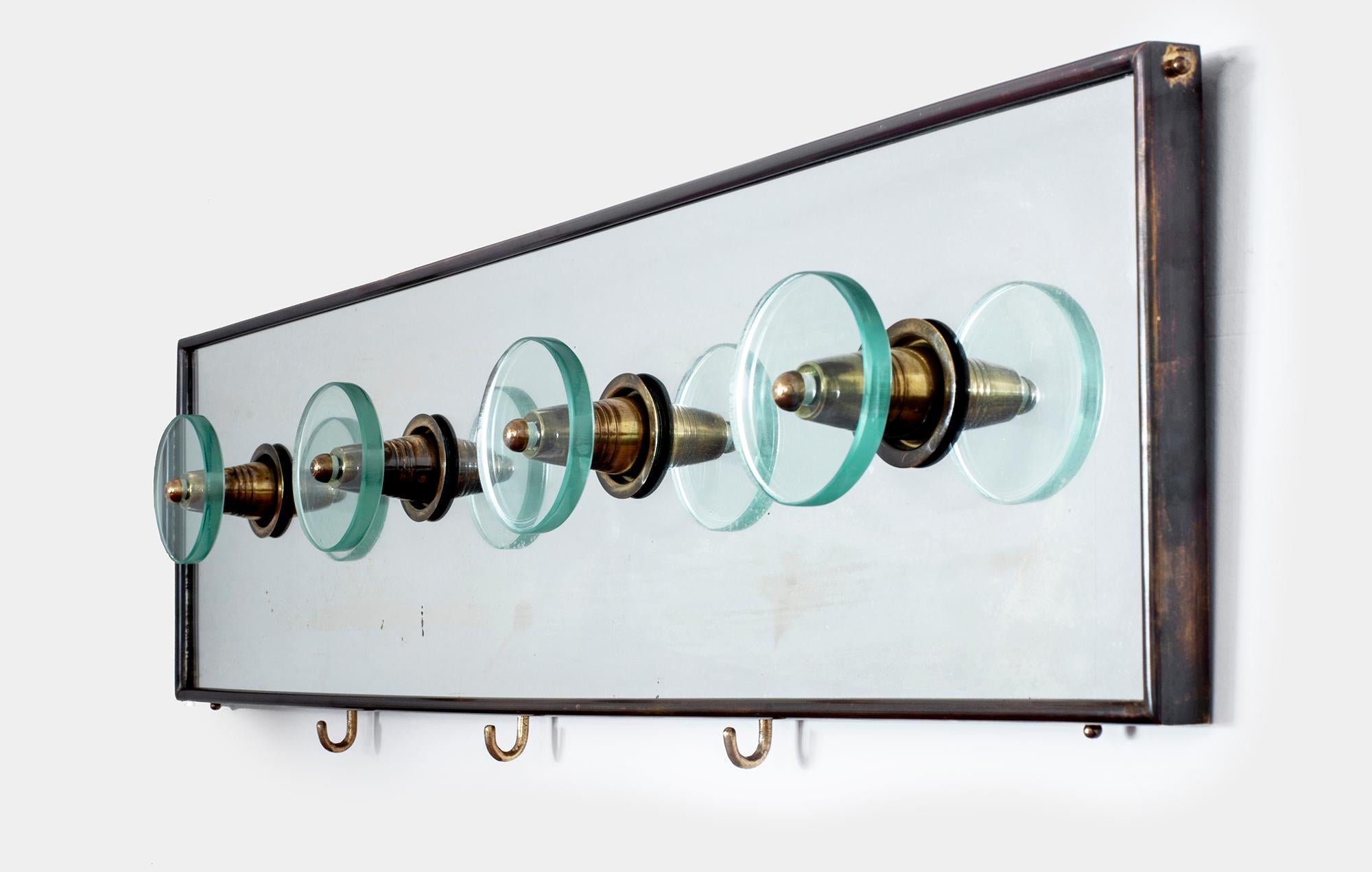 Wall rack coat hanger attributed to crystal Art
Brass, silver crystal and cut crystal coat hangers sitting inside a mirrored with iron frame,
circa 1950s.
      