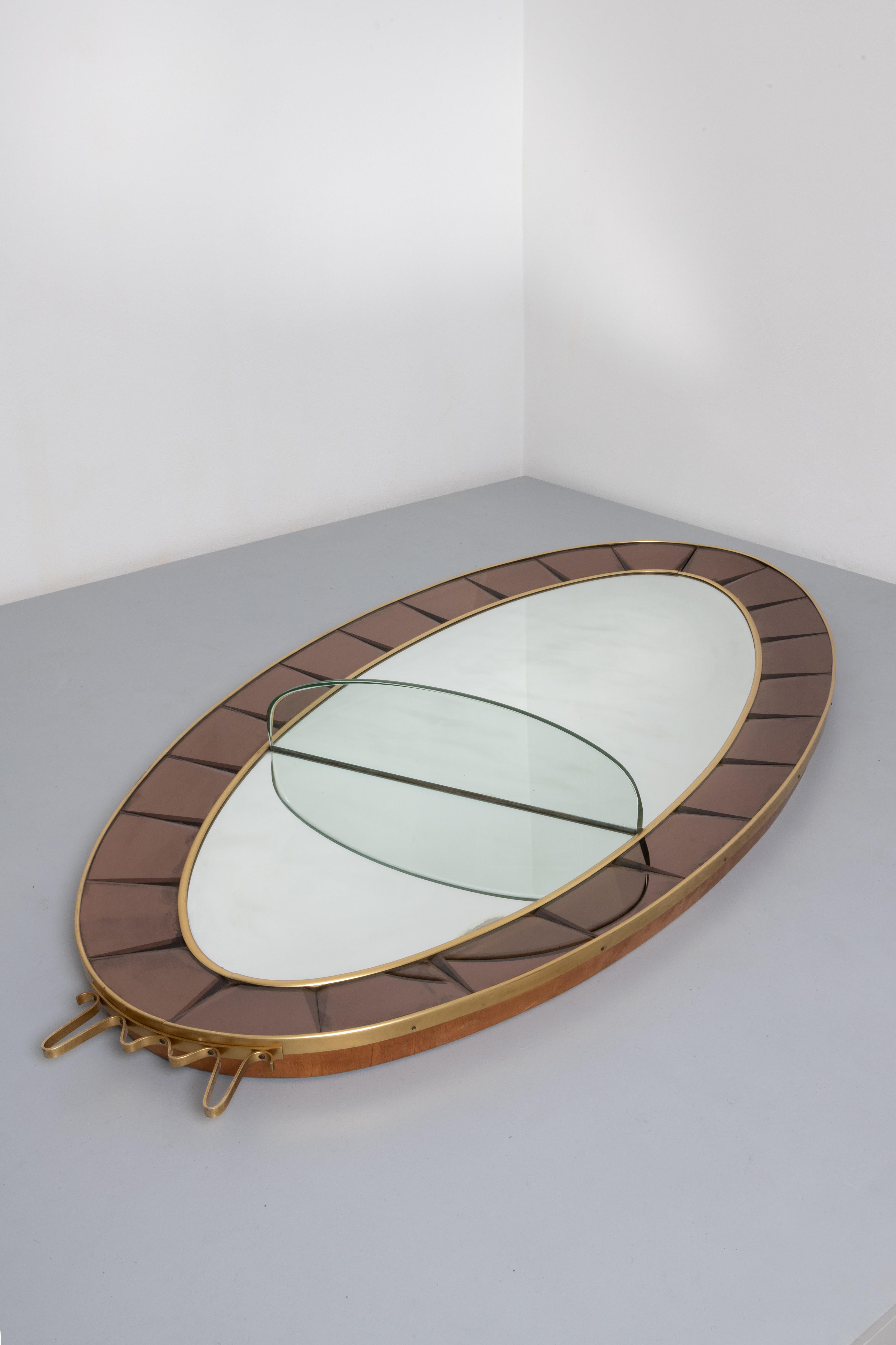 EN - Cristal Art, c. 1950. Mirror with console table. Wooden and brass frame with glass mirror, coloured bevelled crystal frame and thick bevelled crystal console table. 
Wall mirror; mounted on wooden frame with clear glass console.
Wooden frame,