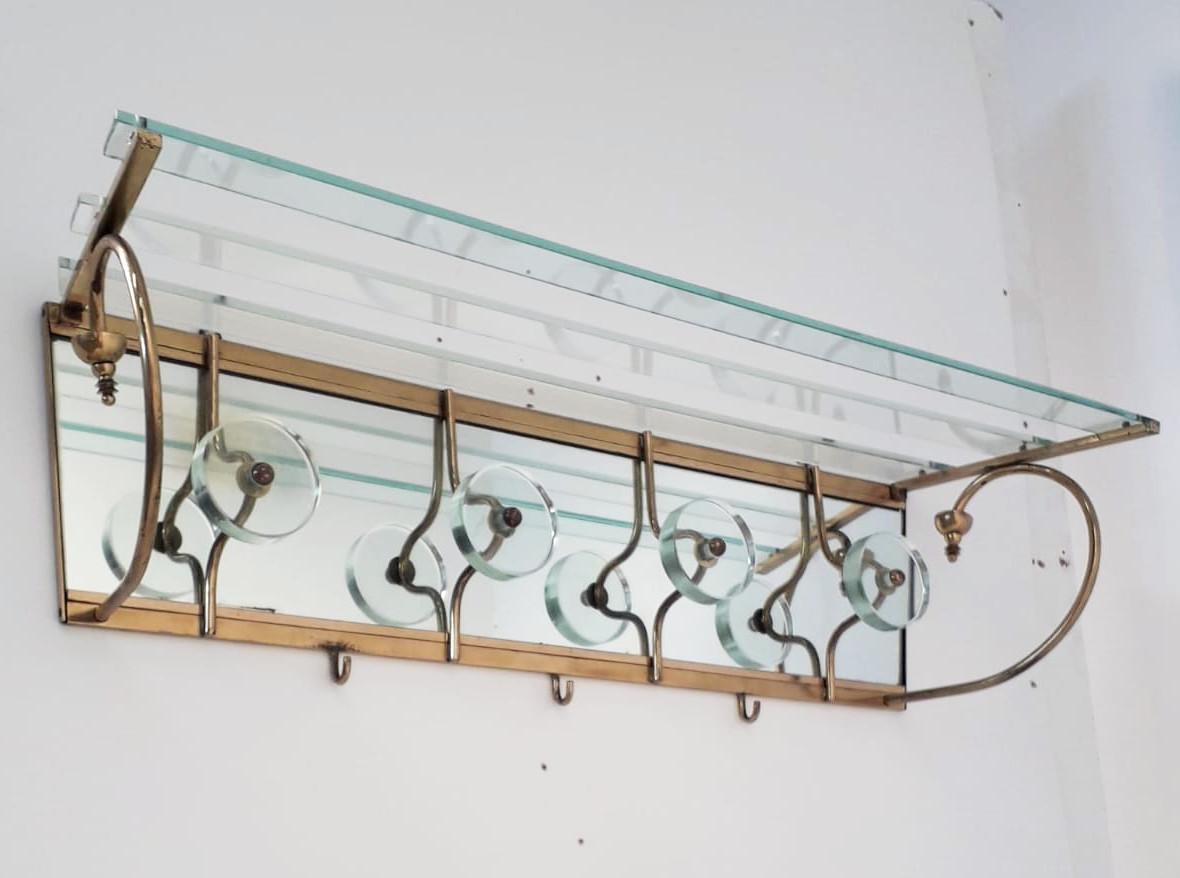 Vintage coat rack with thick beveled glass and brass frame / Made in Italy by Cristal Art circa 1960s
Length: 36.5 inches / Depth: 10 inches / Height: 9 inches
1 in stock in Italy
Order reference #: FABIOLTD F161