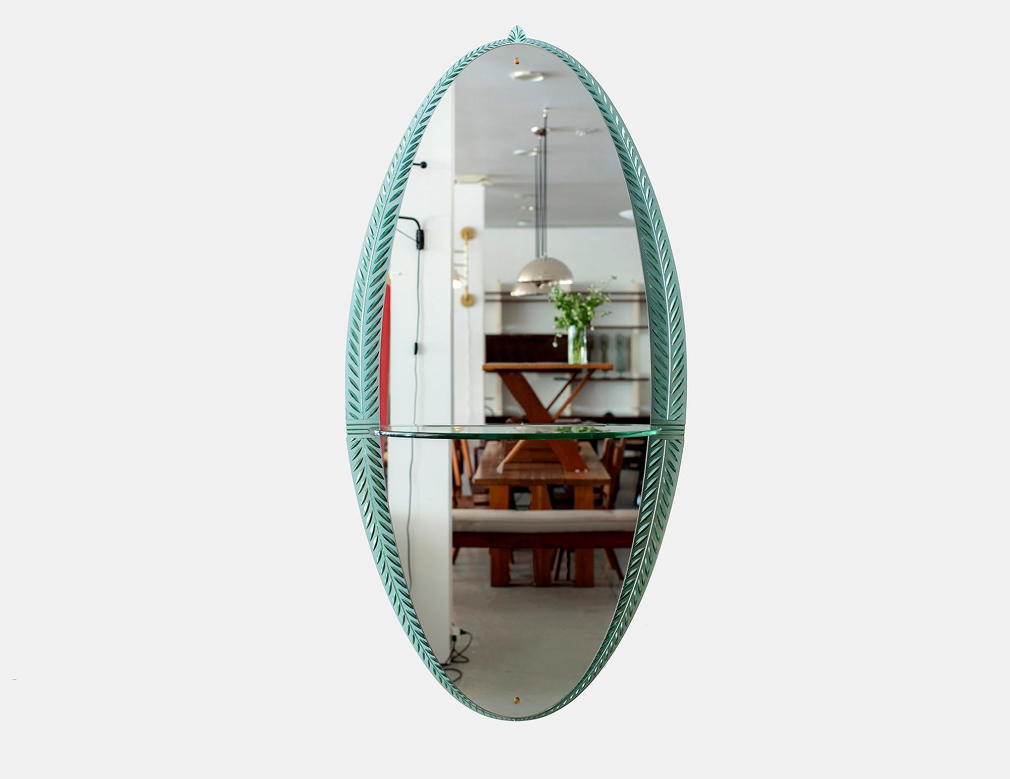 Gorgeous Cristal Art wall mirror, Italy, circa 1955.
Ornate crystal cut glass detailing in oval shape with glass shelf and brass details
Exquisite piece.
