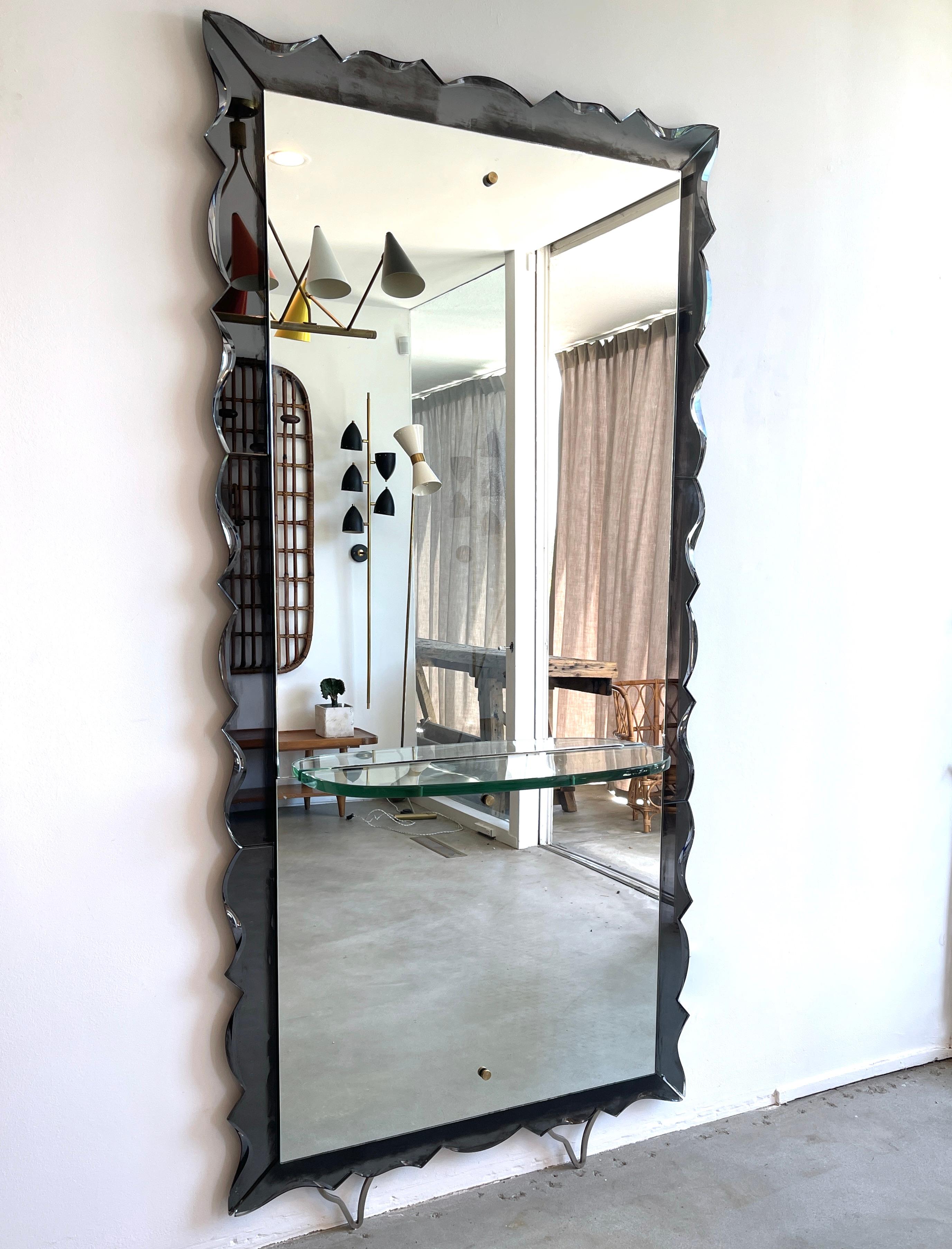 Incredible Cristal Arte leaning wall mirror with scalloped edges
Slate Grey colored mirror on floating legs with glass shelf
Impressive in size.