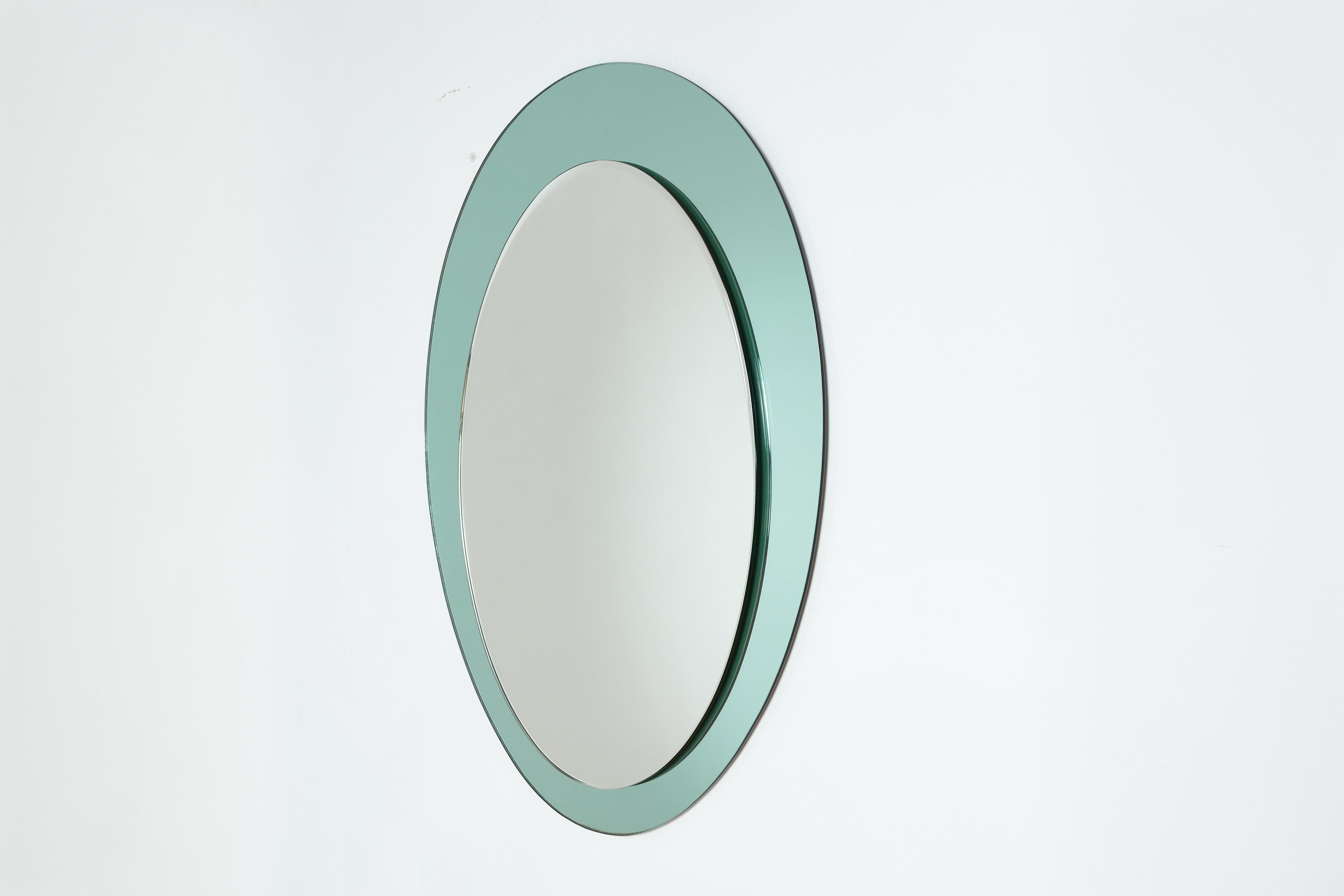 Beautiful Cristal Art wall mirror in unique oblong oval shape  
Italy, 1960s. 
Pale blue colored crystal with original silvered mirror. 
