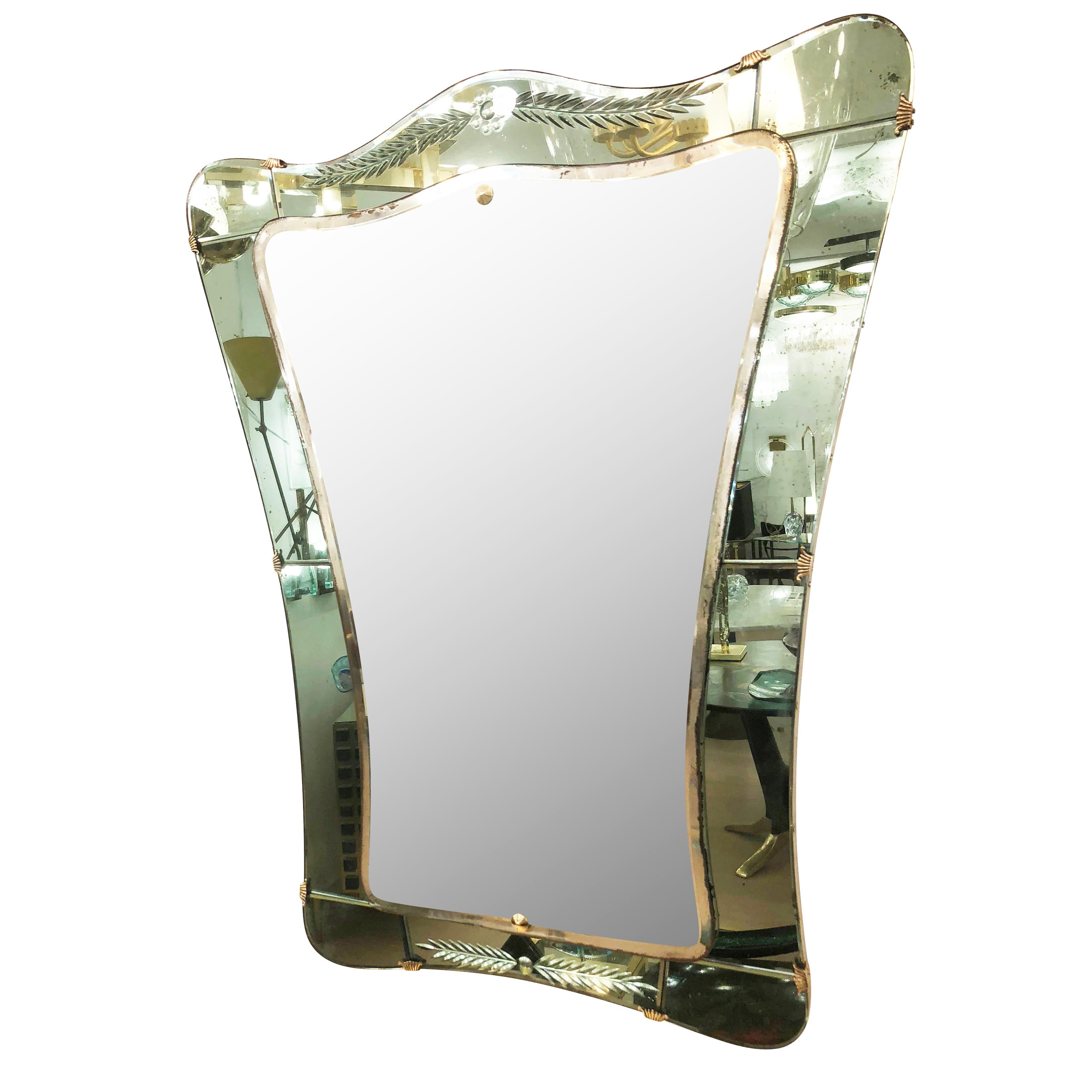 1950s Cristal art mirror with an etched acqua colored frame and brass details.

Condition: Age spots to mirror and frame

Measures: Width 32.5”

Depth 1”

Height 38”.

 