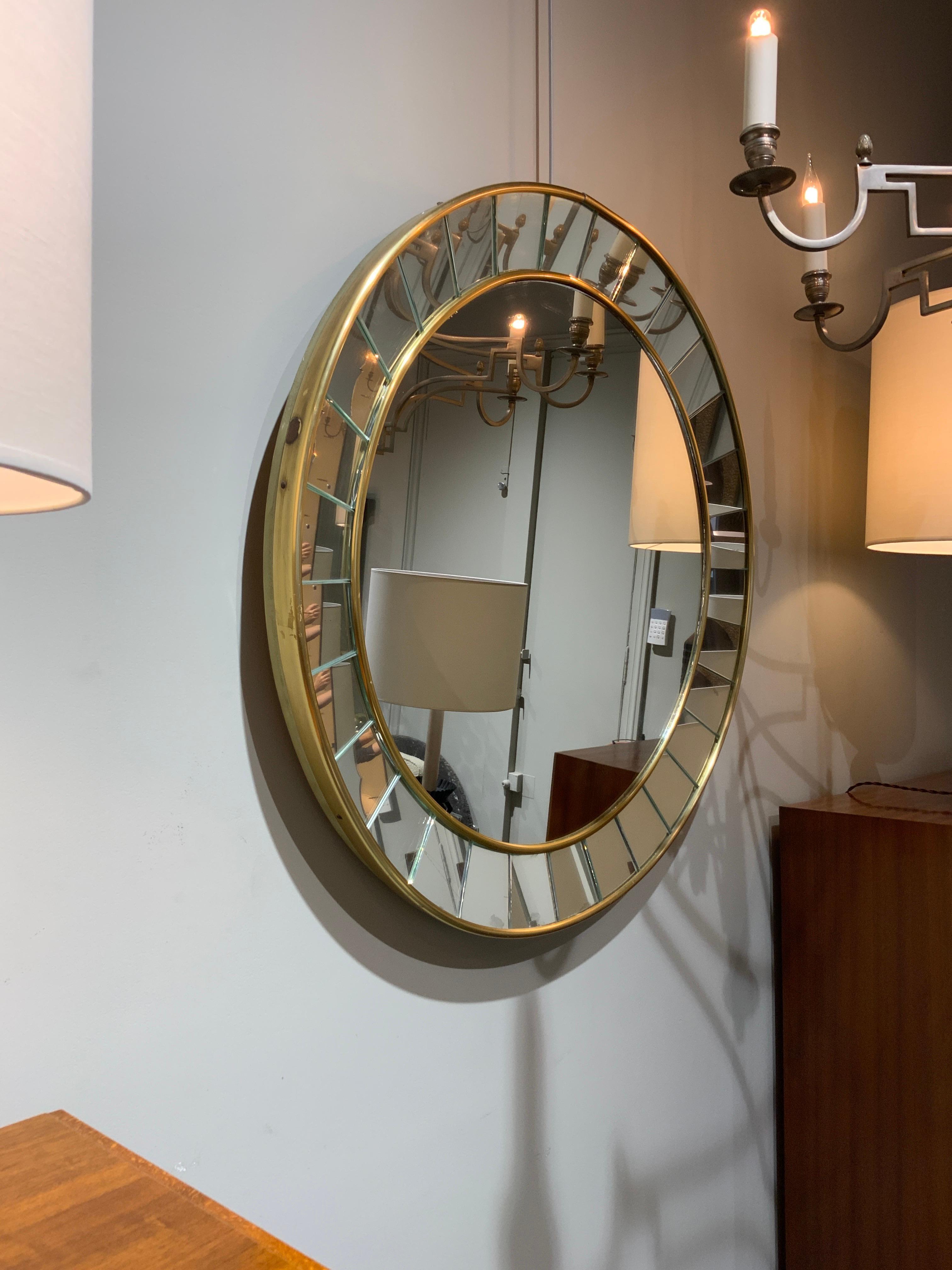 Elegant mirror by Cristal Art Italy circa 1960 cut Glass and brass frame 
Patina on brass and mirror 