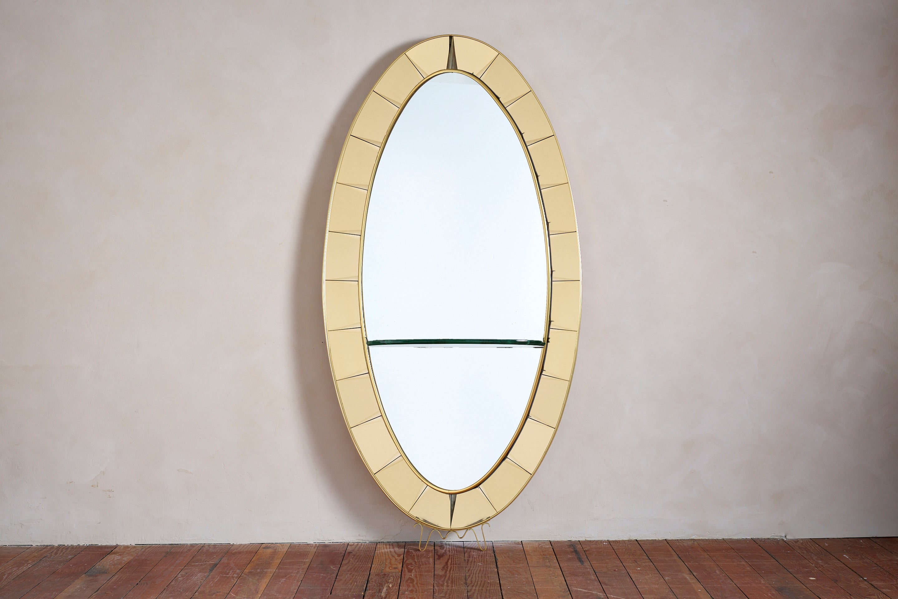 Gorgeous large Cristal Art wall mirror with shelf and gold yellow glass and decorative brass base.

Oval shape with original patina'd mirror and bright yellow gold colored glass 

Italy 1950s.