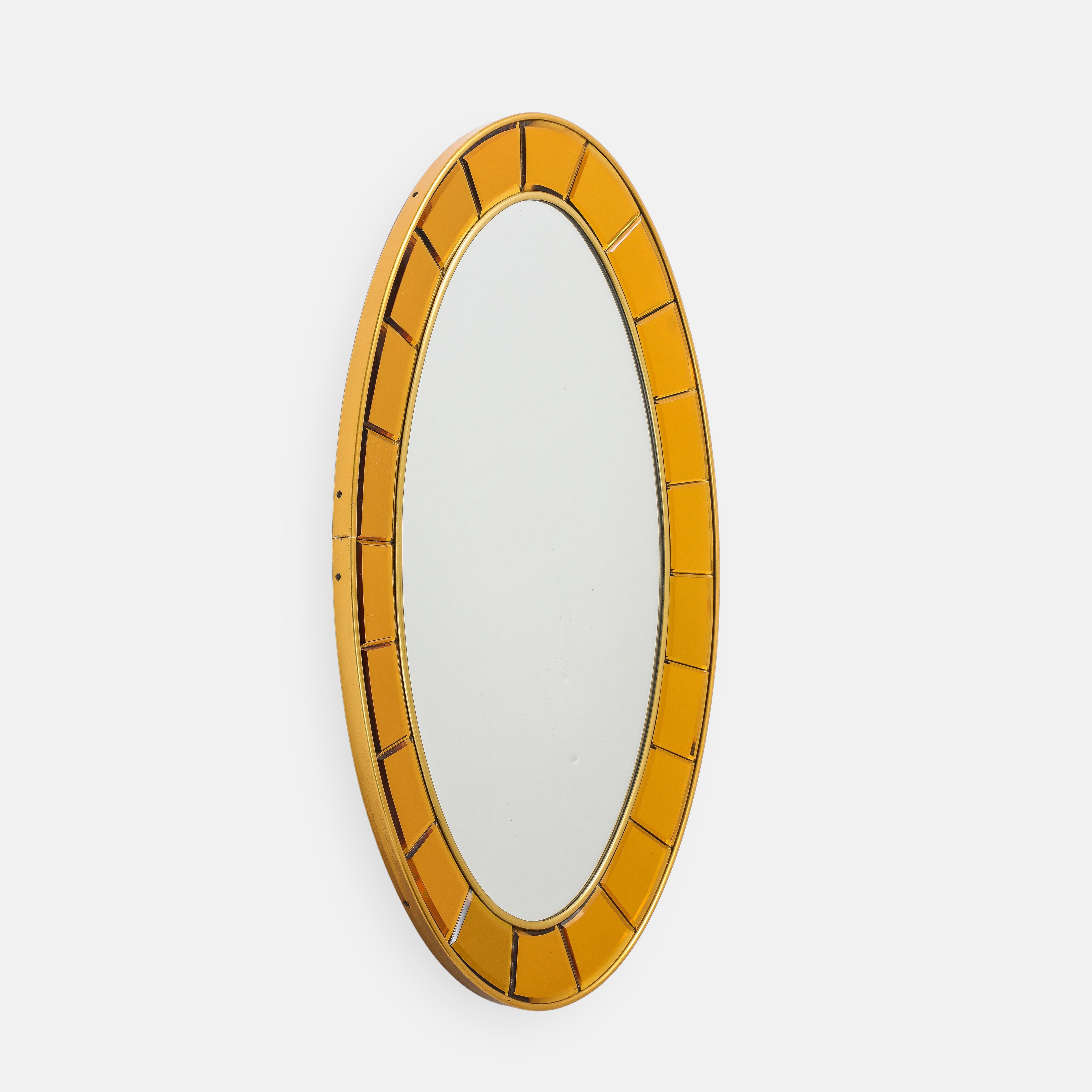 Cristal Art exquisite original oval mirror model 2727 with gold hand-cut, beveled crystal glass pieces framed by gilt brass borders and mirrored glass on a wooden backing. This stunning mirror is hand-crafted with intense bright blue beveled
