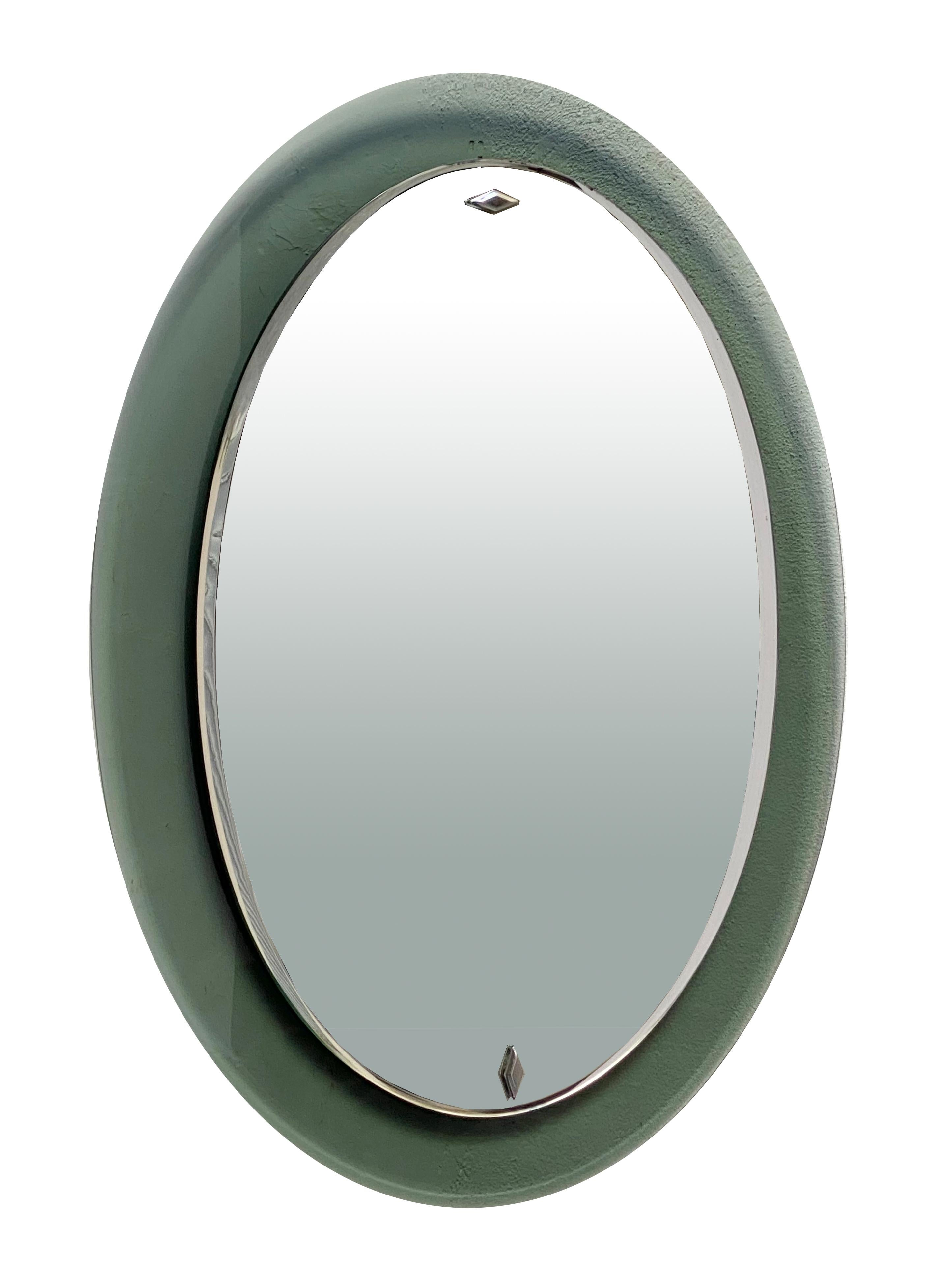 1960s oval mirror produced by Cristal Art in Italy. 
Light green frame, curved ground glass.
