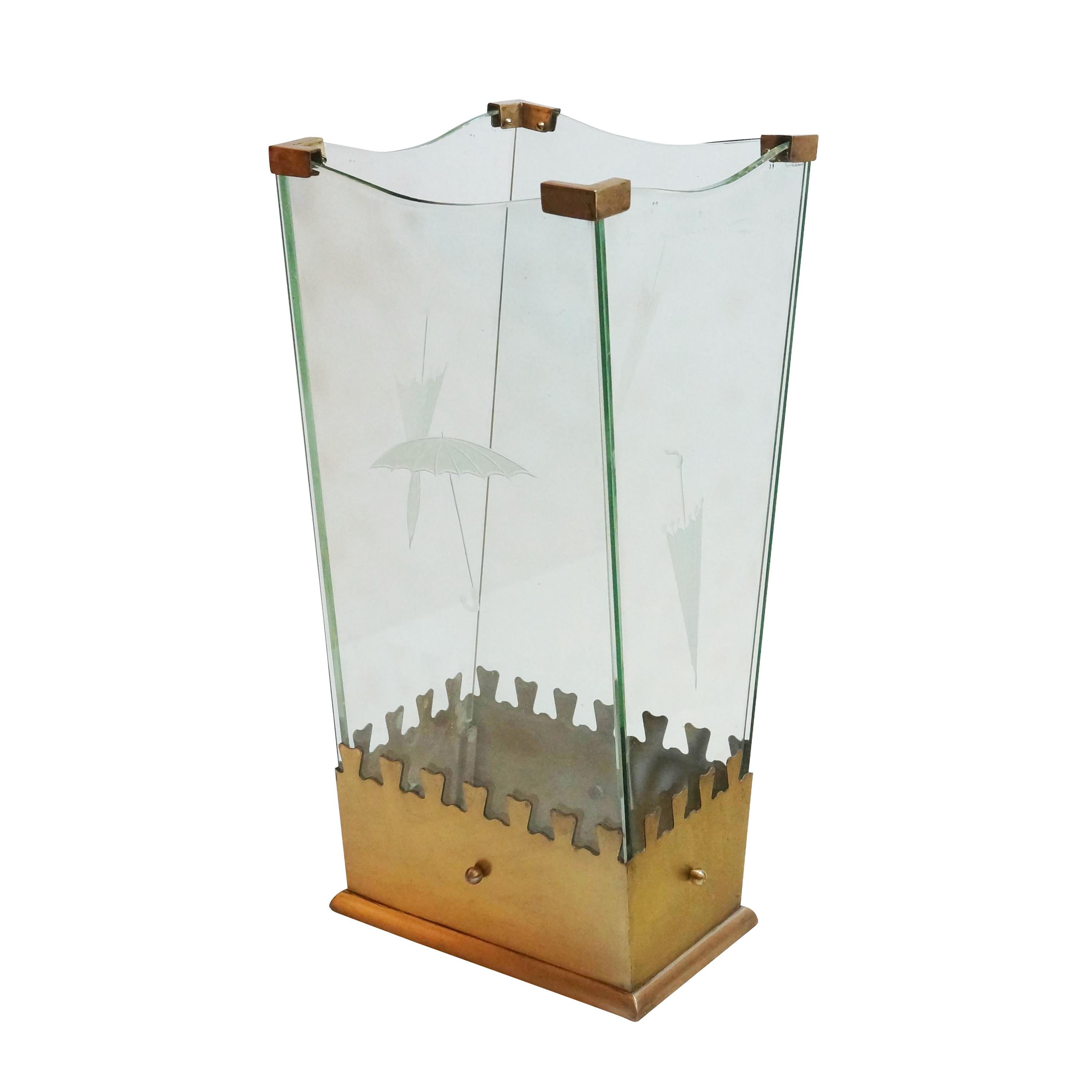 Playful glass and brass umbrella stand by crystal Art. Each of the four glass pieces has an etched image of an umbrella. The base is lacquered gold  while the hinges at the corners are brass.

Condition: Excellent vintage condition, minor wear