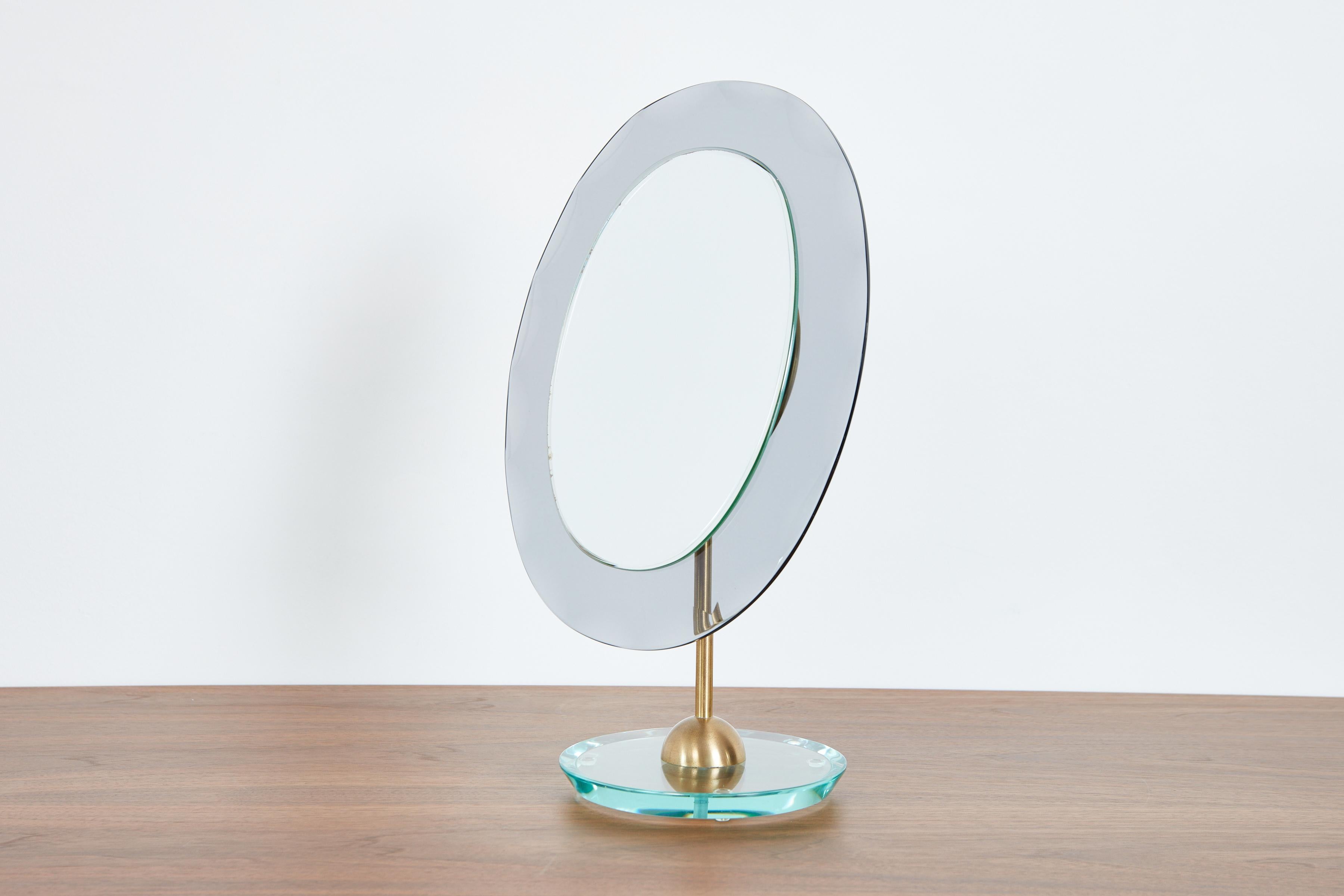 Cristal Art Table Vanity mirror with smoked glass oval, brass and thick glass base. 
Italy, 1960's
Wonderful piece! 
