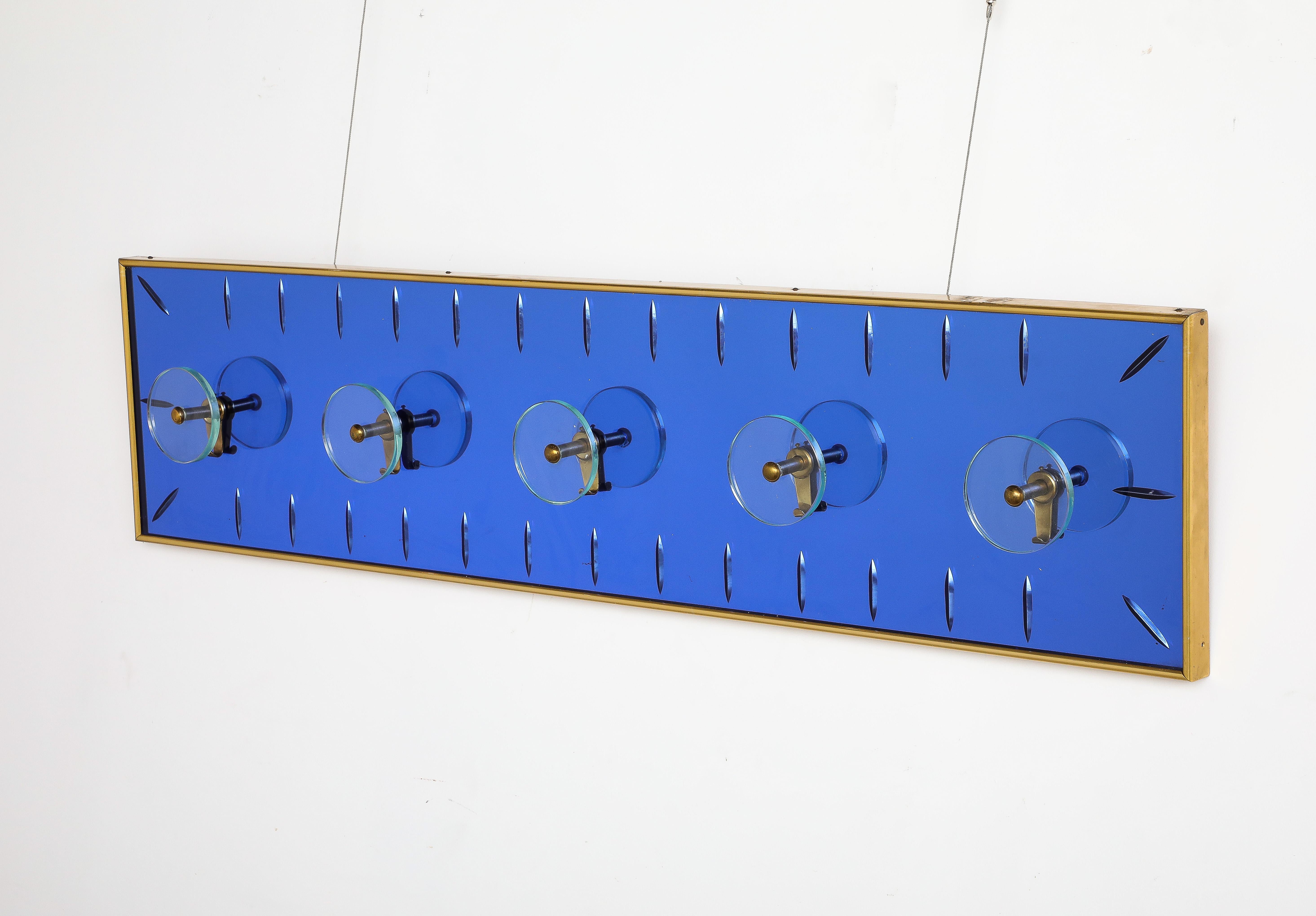 Cristal Art Wall Mounted Blue Glass Coat or Hat Rack, Turin Italy, circa 1950's 

A very rare and stunning grand scale wall-mounted coat rack by Cristal Art, the back plate glass in an electrifying blue color with hand-cut facets.  With 5 brass