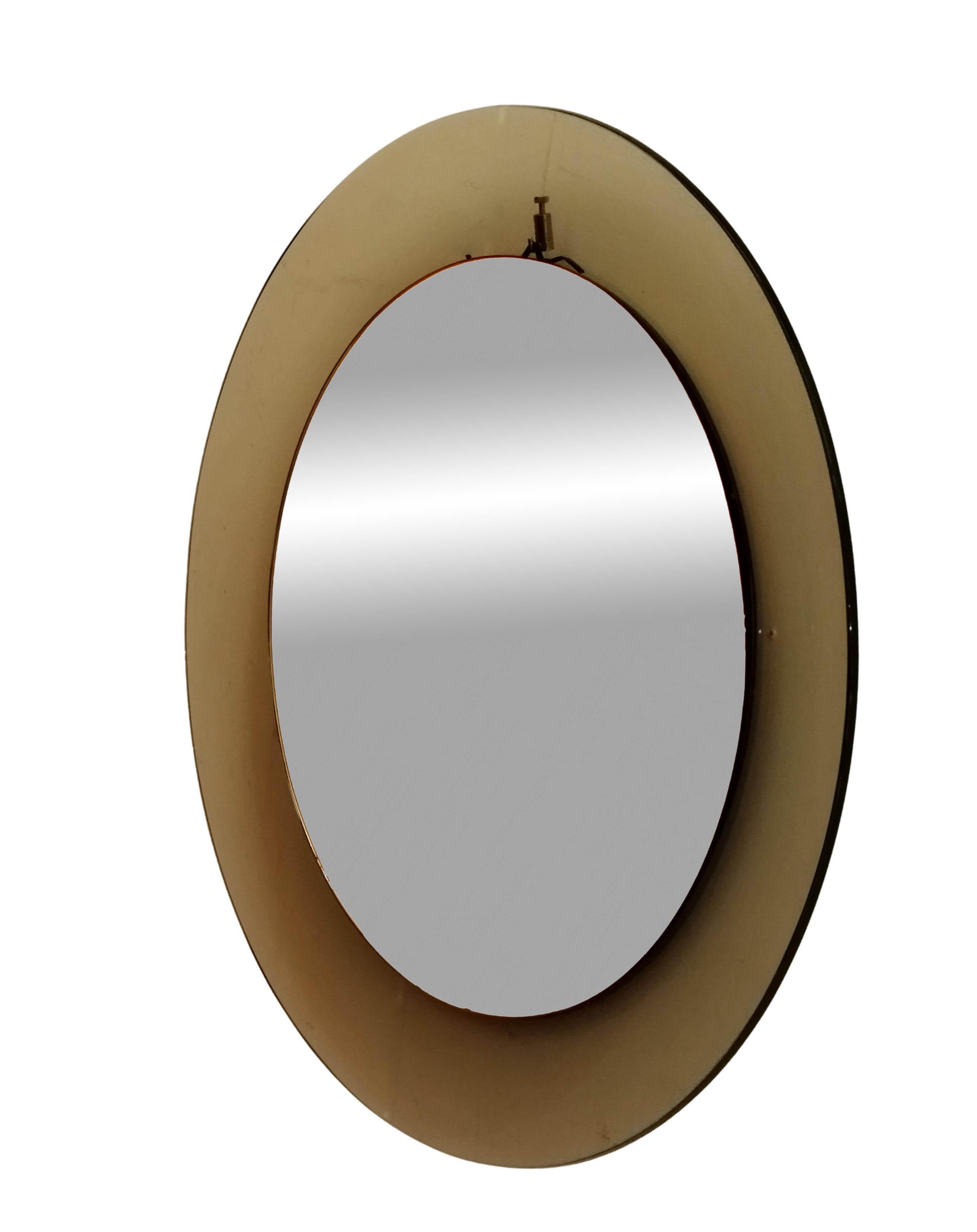 Circular Murano glass wall mirror, Prod. Cristal Art, Italy circa 1960, amber concave shaped glass, mirror glass, wooden suspension. Very good state of preservation. 



