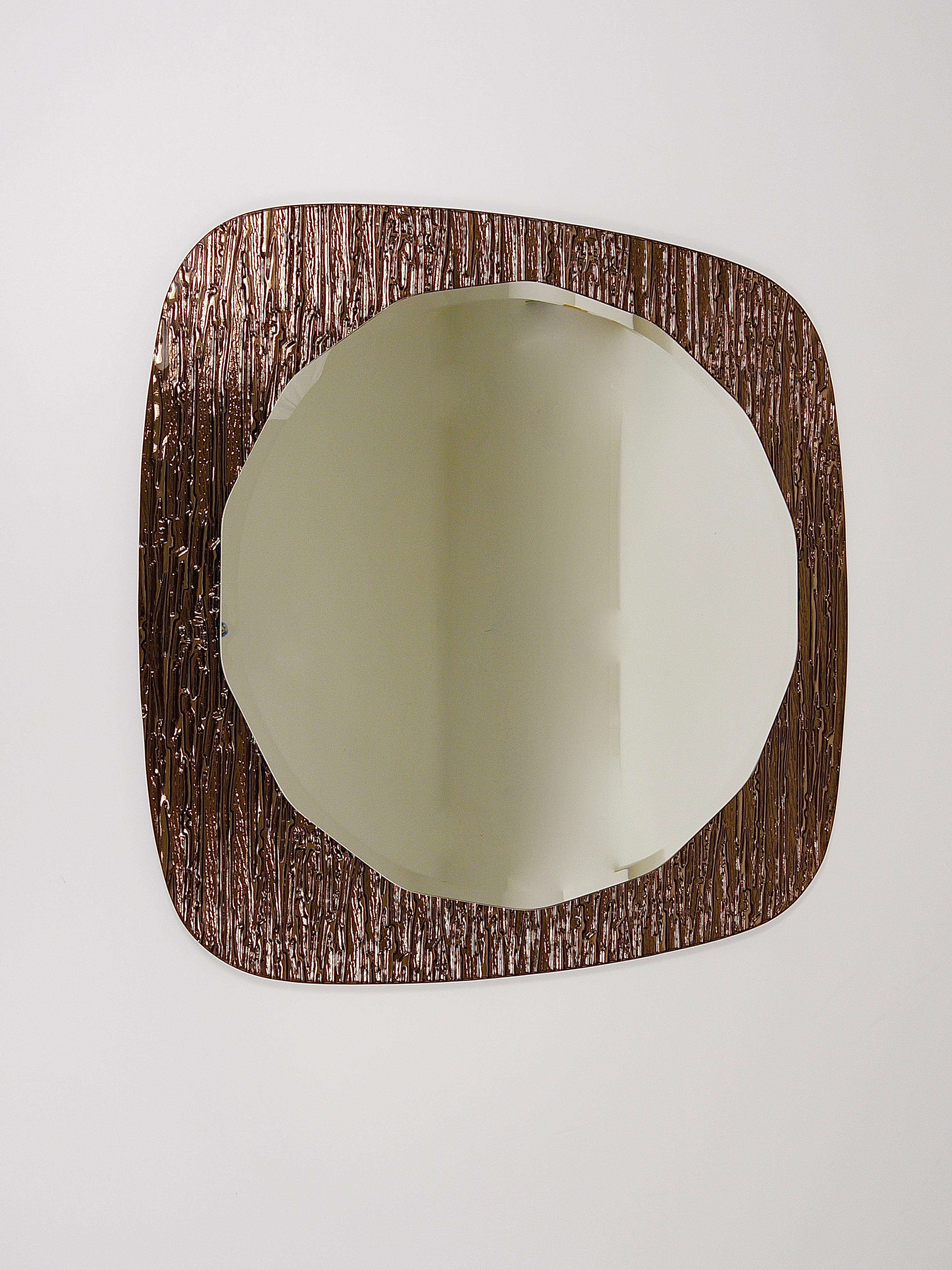 An impressive and premium-quality double-levelled Italian wall mirror from the 1960s, made in Italy by Cristal Arte / Crystal Arte. It features a round scalloped and faceted mirror on a brown bronze goldish backplate mirror glass. The backplate has
