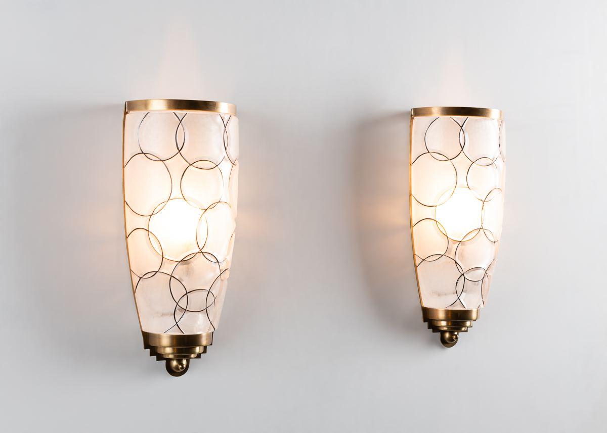 Inspired by the work of Emile-Jacques Ruhlmann, this beautifully proportioned sconce possesses traditional deco bronze details and a large crystal shade handcut into a playful relief of overlapping circles

Edition of 99.
