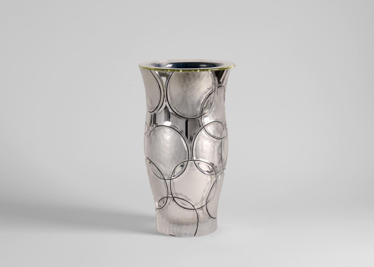 This enameled and silvered glass crystal vase, featuring a playful arrangement of overlapping circles, exemplifies Martin Benito's mastery of a craft honed by his family for generations in France.

Benito begins his process by tracing the lines of