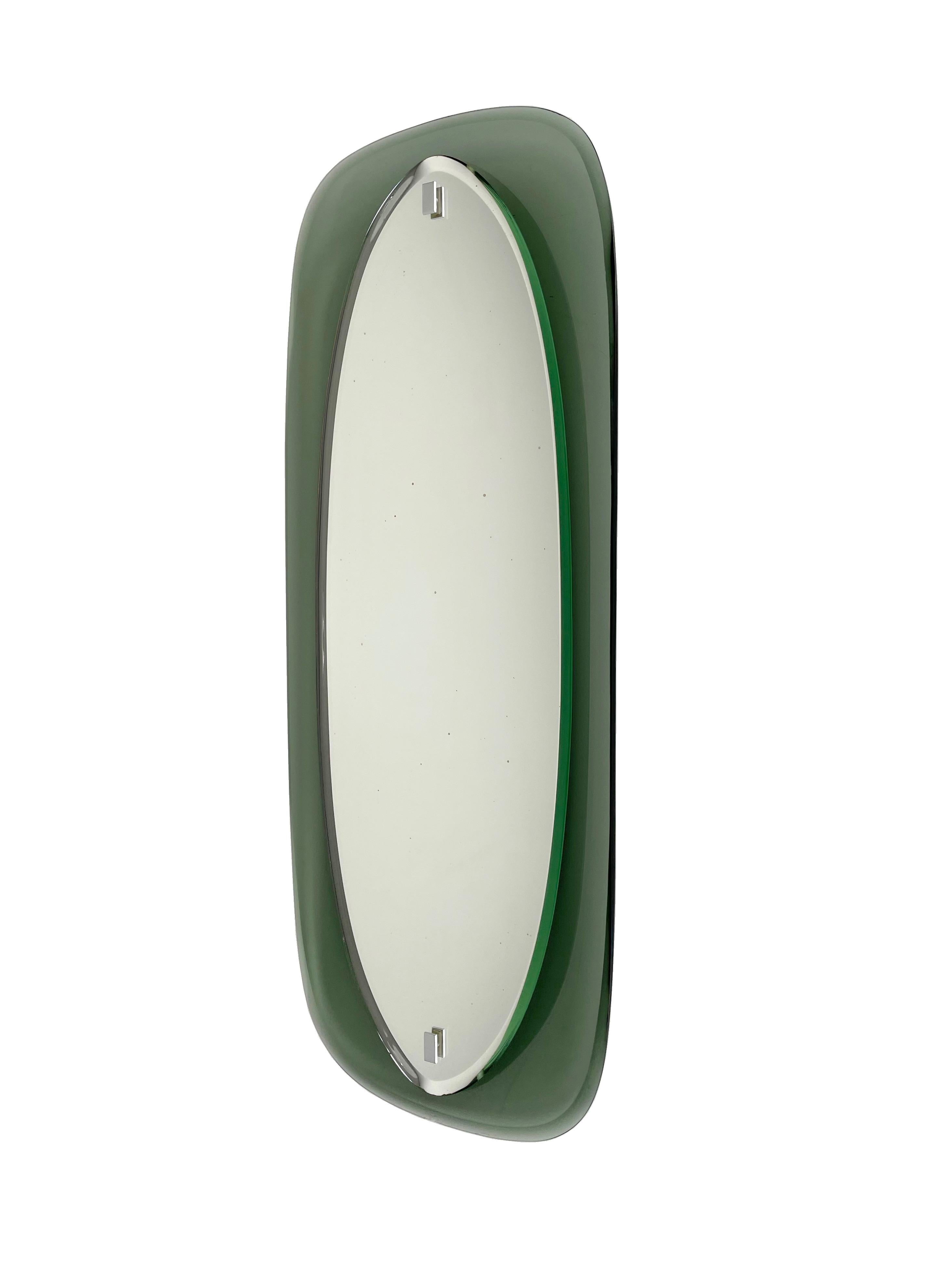 Mid-Century Modern wall mirror by Cristal Labor S.p.A. made in Italy in the 1960s. As shown in the pictures, it presents a light chipping on the bottom of the glass. 
The original label is still attached on the back of the mirror.