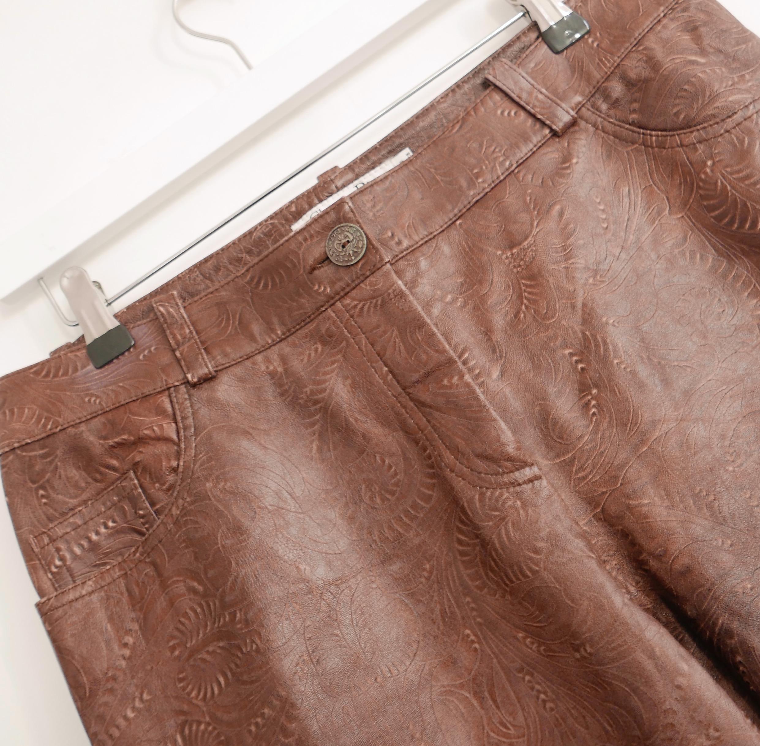 Rarest Christian Dior x Galliano leather trousers from the Spring 2006 collection. In amazing unworn with tag/spare button condition. Made from Western inspired, fully tooled brown leather with embroidered back pockets and vintaged metal button to
