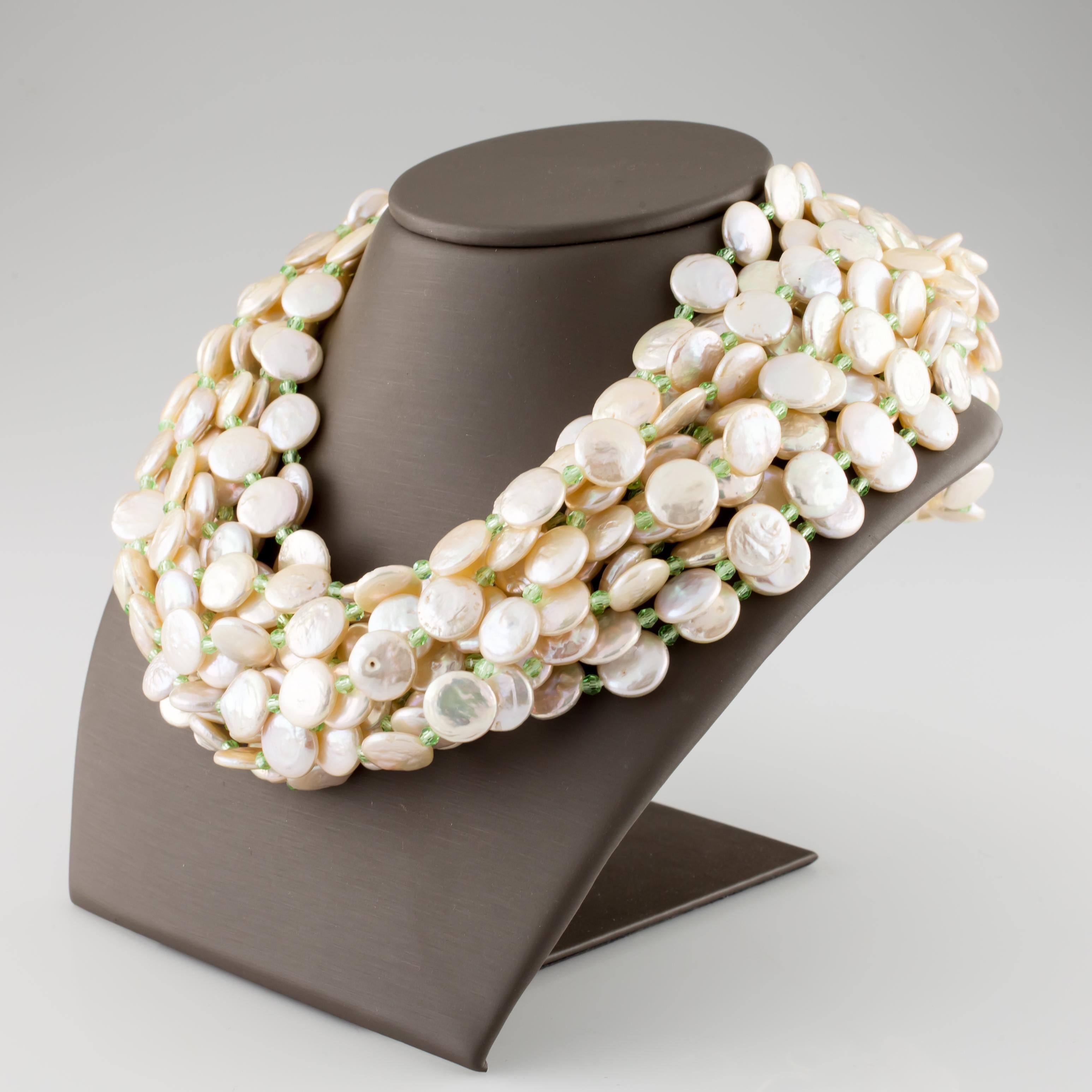 Amazing Multi-Strand Pearl Necklace by Cristina Ferrare
Features 11 strands of coin pearls interspersed w/ small briolette-cut green stones
Approximate diameter of coin pearls = 10 - 11 mm
Includes 18k Yellow- and White-Gold Clasp
Total Length =