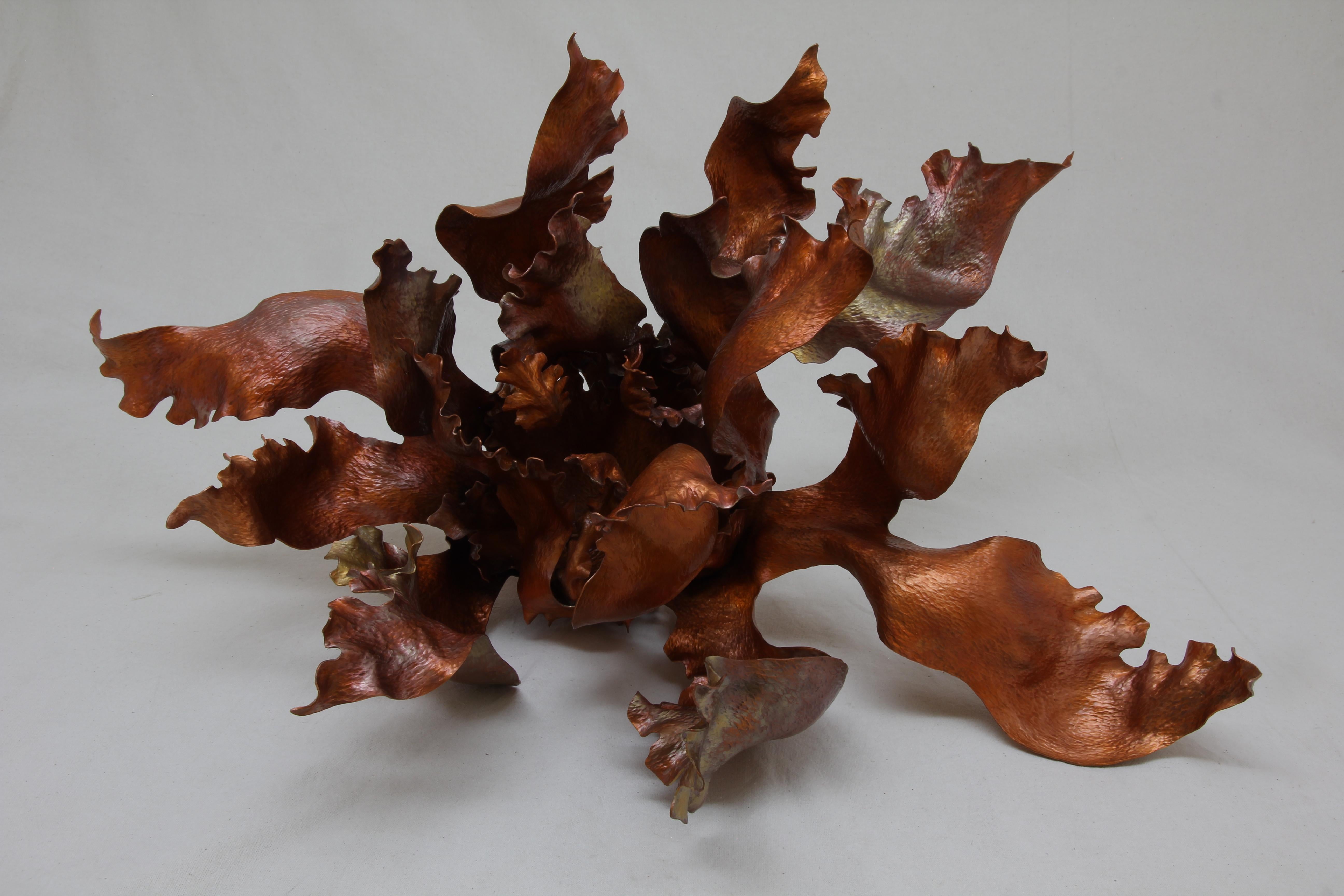 Inspired by the wonderful shapes in nature, this organic centerpiece is made out of heat-treated copper, 100% hand made by expert craftsmen, each sheet of metal is hand hammered, cut and twisted using metal and or wood as a last to give each ruffle,